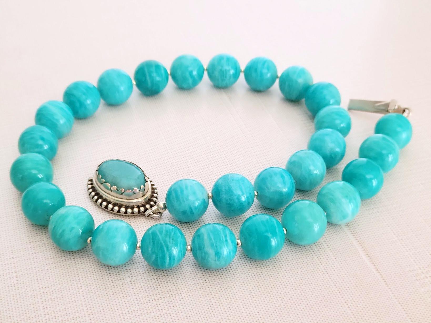 The necklace is 19.5 inches (49.5 cm) long, and the smooth round beads are 15 mm in size.
The beads are sea blue and turquoise, with very subtle soft streaks. We are guaranteed 100% natural Peruvian Amazonite, not treated in any way. The beads are