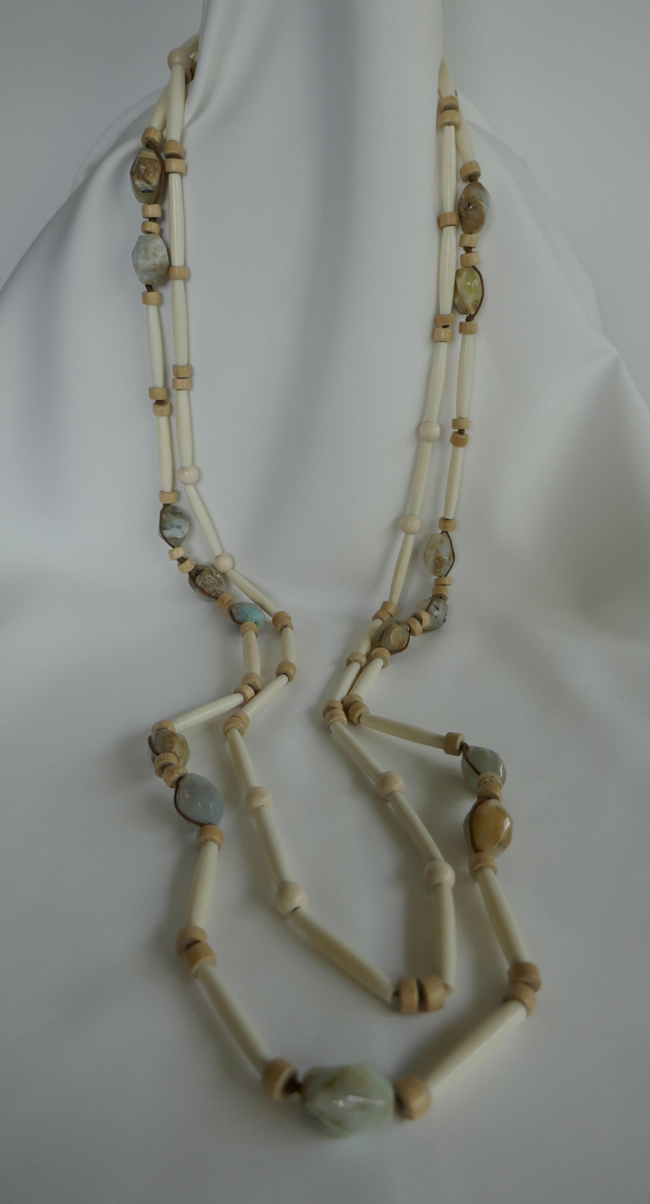 If you like unique pieces this is definitely one to own. This two strand necklace combines Peruvian opal (Pale Blue, Beige, Crème) nuggets, with bleached horn tubes and two shapes of Pale wood. The clasp is macramé and Peruvian Opal Nuggets. The