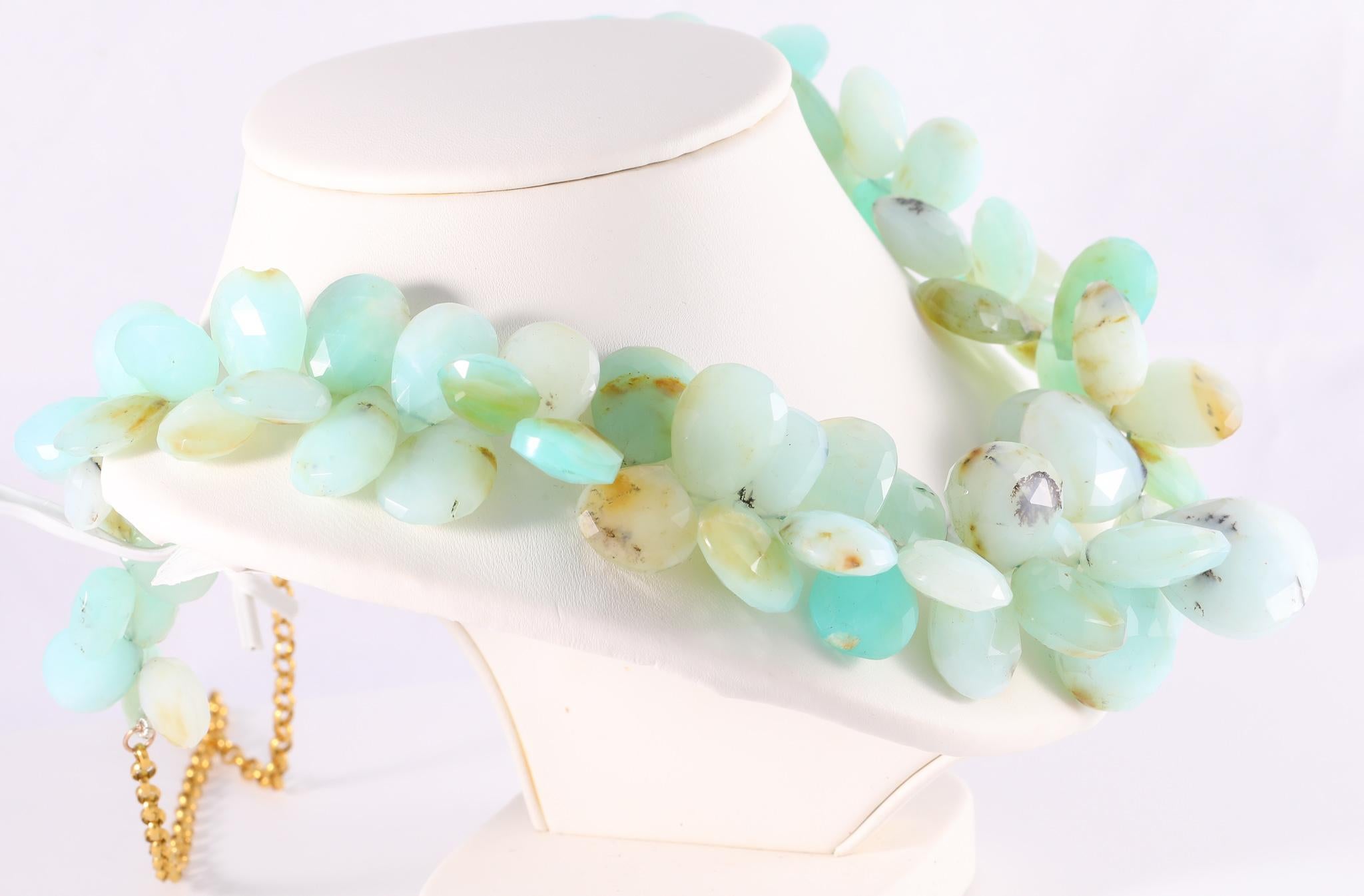 This dazzling cluster of natural Peruvian opal beads is like the colors of the Caribbean ocean. The faceted briolettes sparkle and shine. Feel like you're on vacation, or take it to the tropics, either way you'll always feel a breath of fresh air