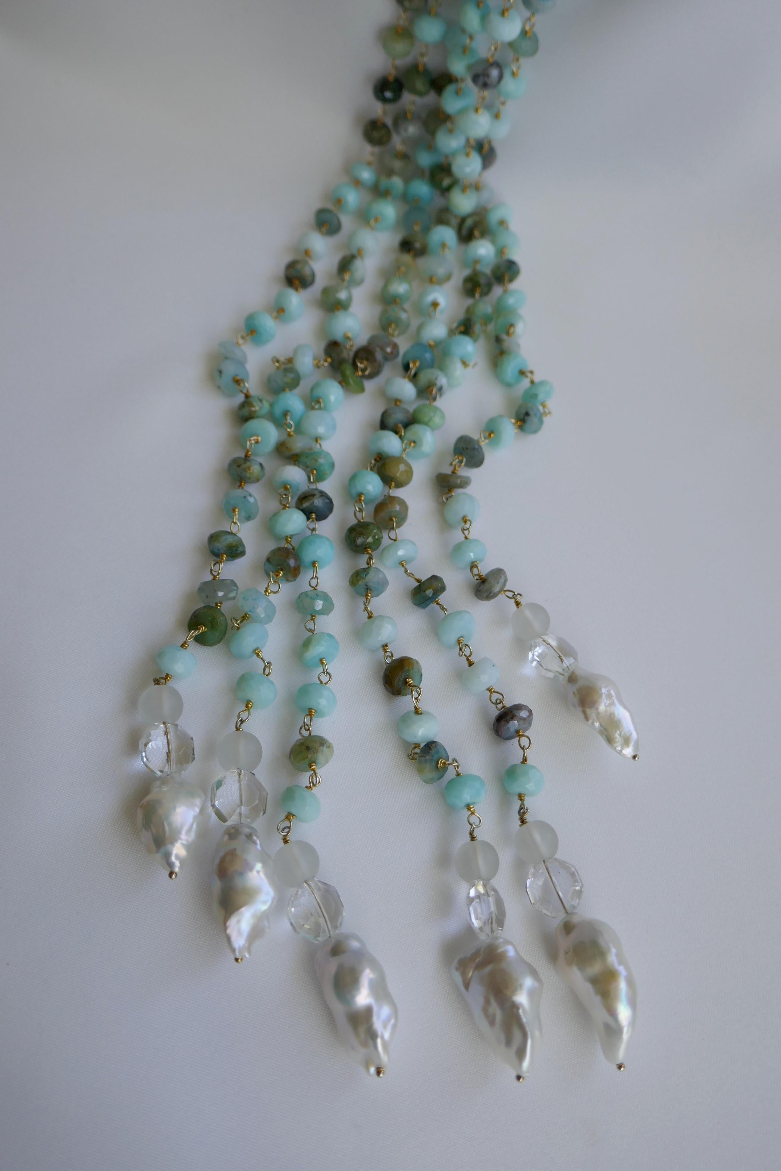 This is a three individual strand Peruvian opal (aquamarine in color) faceted roundels 8-9mm lariat necklace finished with frosted and polished rock crystal and baroque cultured pearls. The Peruvian Opal beads are wired wrapped in vermeil 925