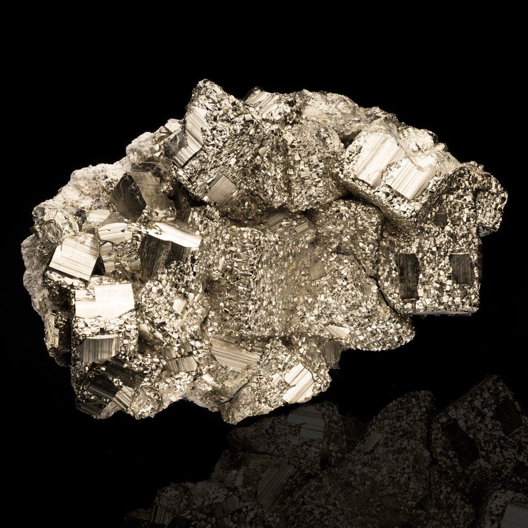 This huge, textural, incredibly reflective and intricately crystallized museum grade pyrite cluster from Peru displays large, mirror-lustrous crystals juxtaposed with smaller also fully formed crystals that appear almost massive when viewed from