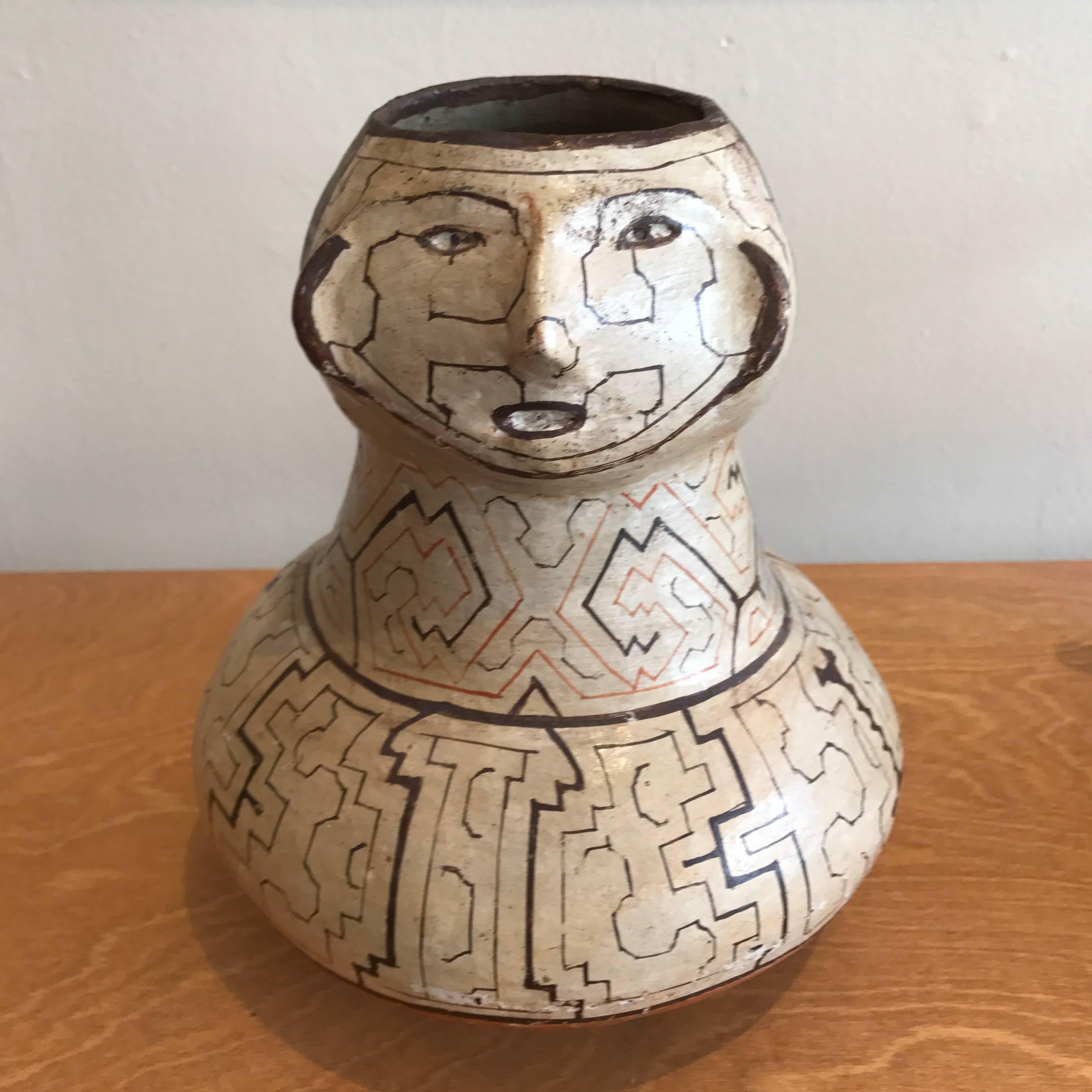 Early 20th century Shipibo vase or urn, nice form and embellishments, no structural damage or repairs, just minor wear to the resin finish from age and use.