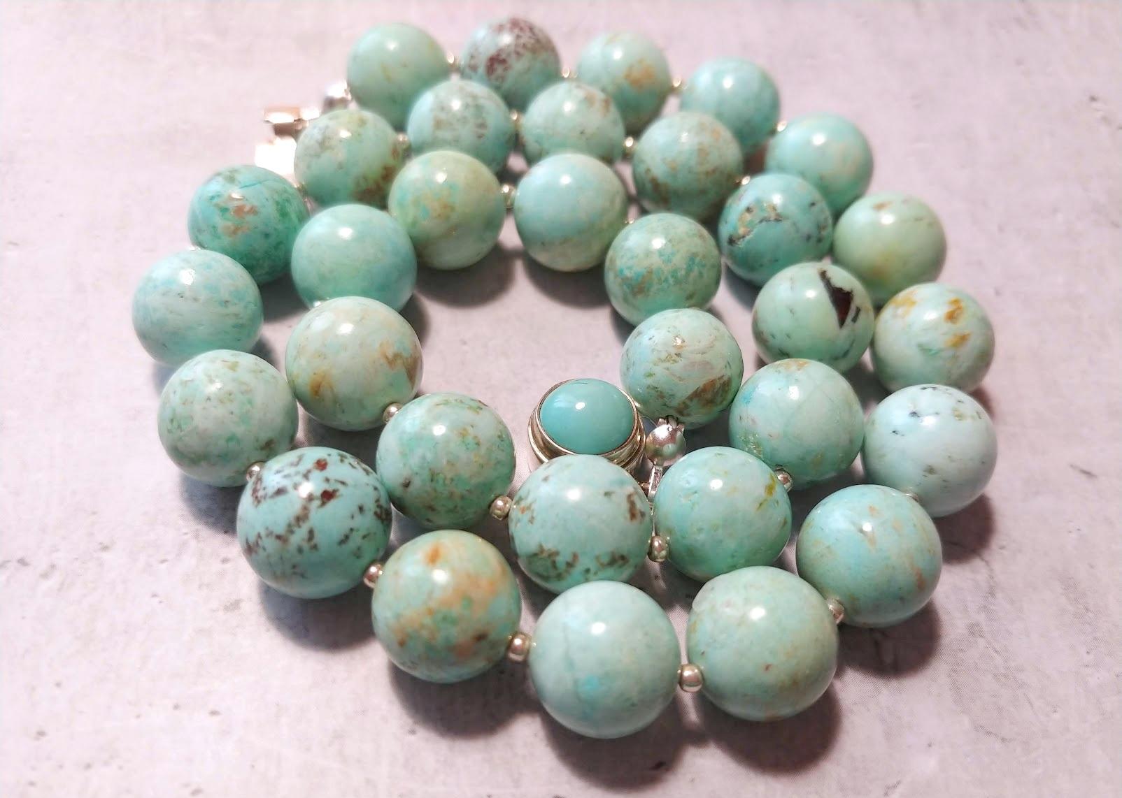 The length of the necklace is 18 inches (45.7 cm). The size of the smooth round beads is 12 mm.
The beads' color is a light sky blue, delight aquamarine with delicate veining, Swainson's thrush eggs, and robin's egg blue. In bright sunlight, the