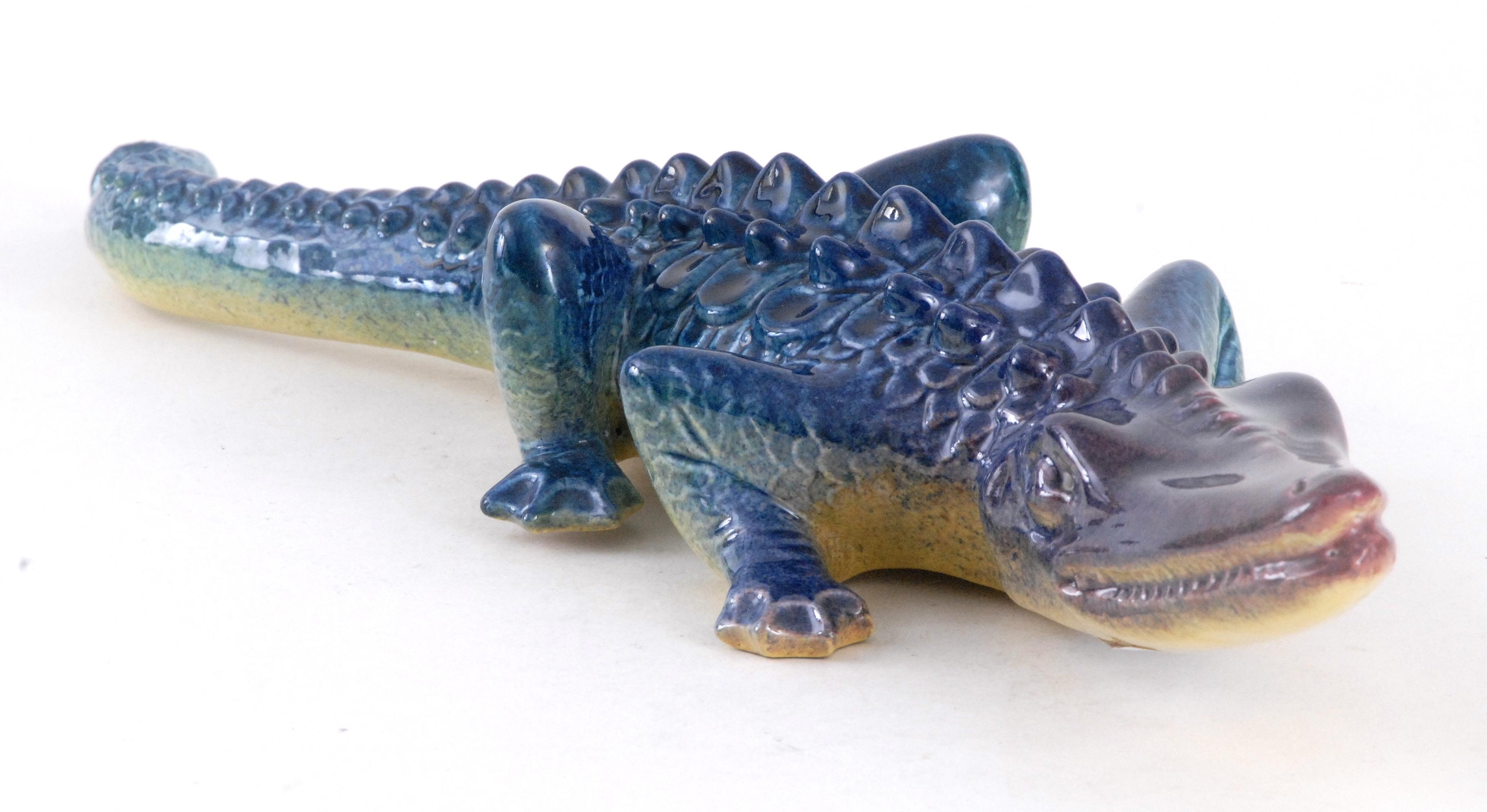 An impressive crocodile by Renato Giavoli made in the early 1950s at his factory in Pesaro Italy. He was a maestro of Italian ceramics and this is being carried on by Adriano Giavoli. A great piece for a sideboard or shelving to offset the vertical