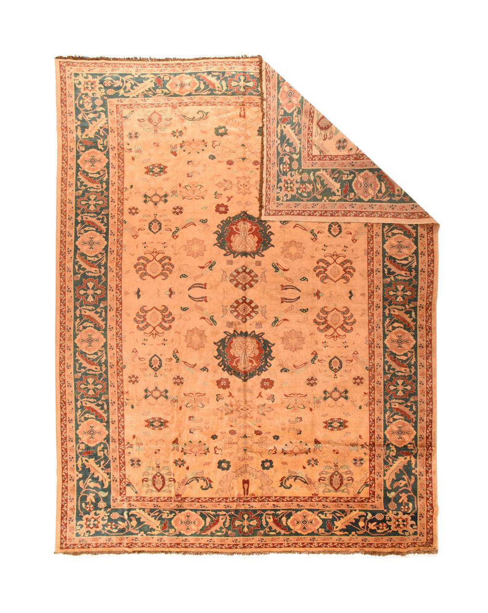 Peshawar Rug 13'0'' x 17'4''. The cream field shows two addorsed red and blue-green ragged palmettes along the centre line, flanked by 
