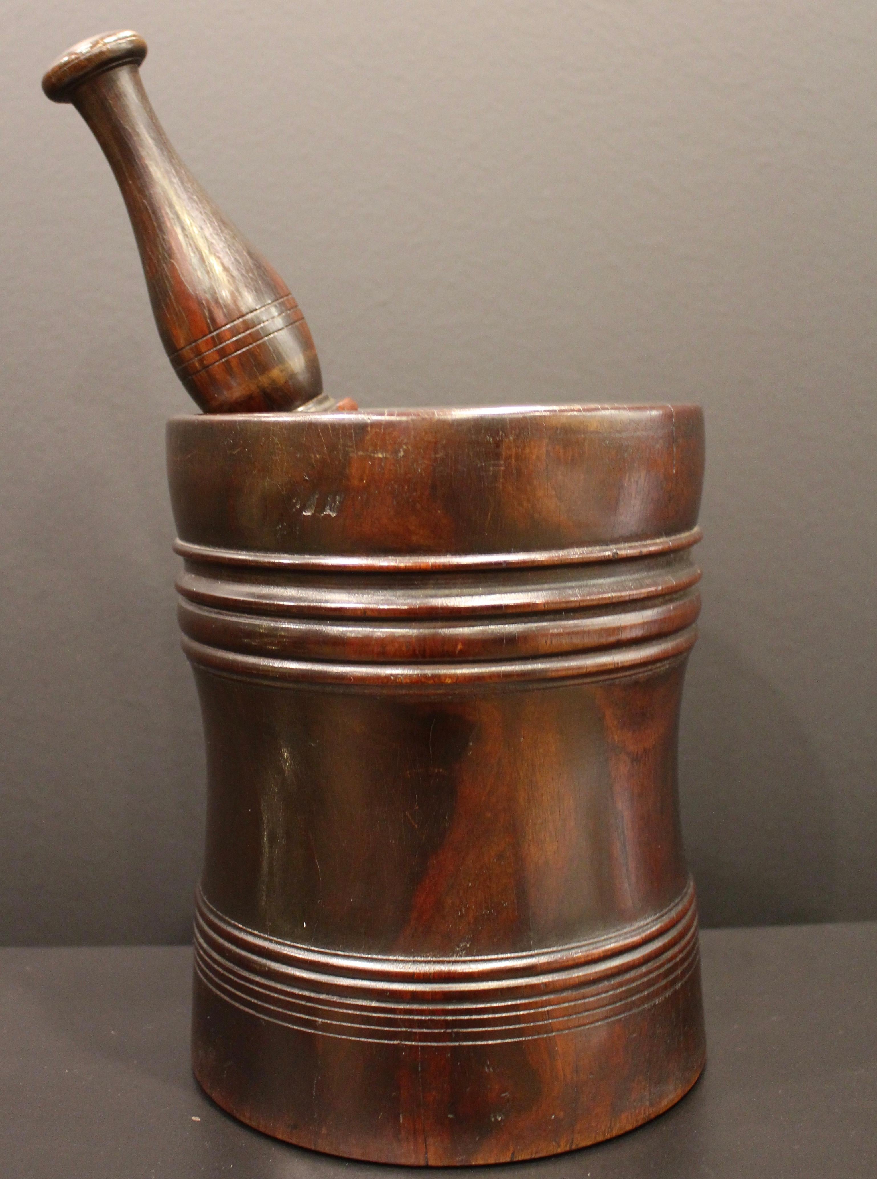 A magnificent early 18th century lignum vitae pestle and mortar.