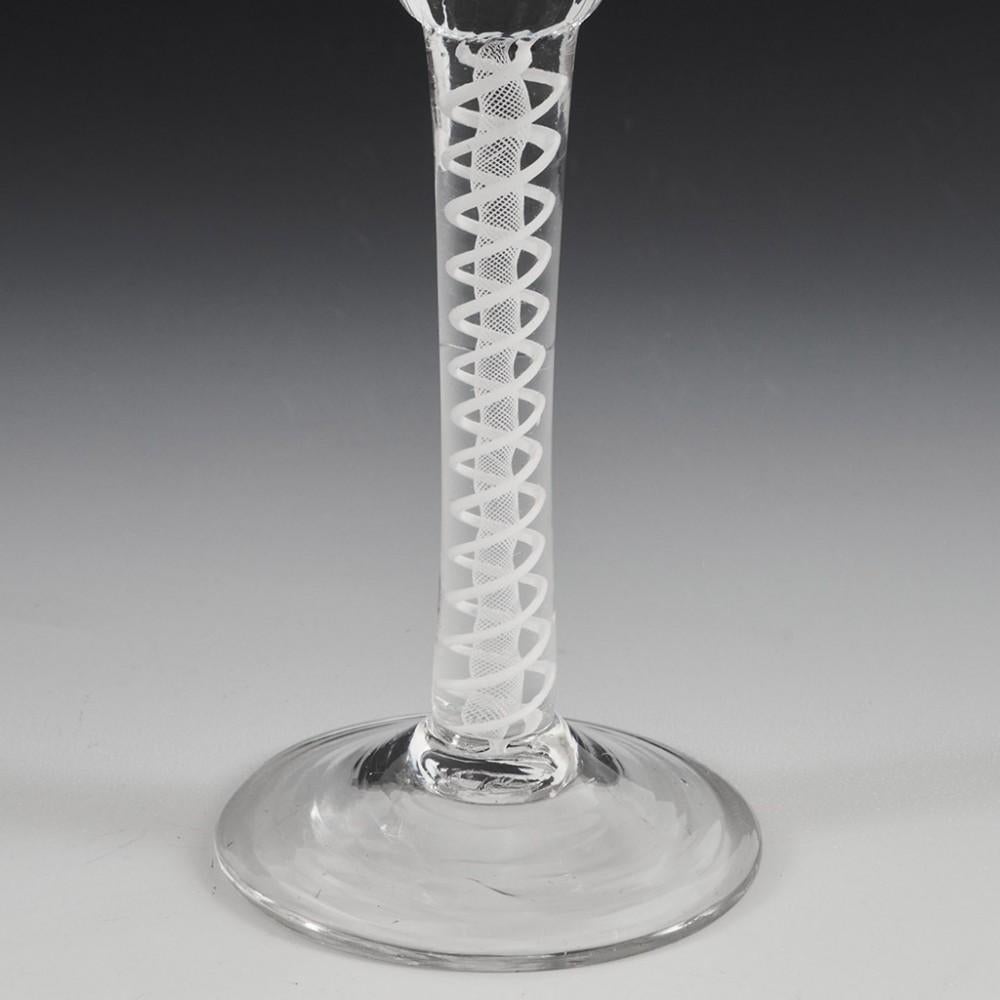 Heading : Petal moulded opaque twist cordial glass
Period : George II / George III
Origin : England
Colour : Clear
Bowl : Round funnel with solid basal section and petal moulding
Stem : A pair of spiral threads outwith a spiral gauze
Foot :
