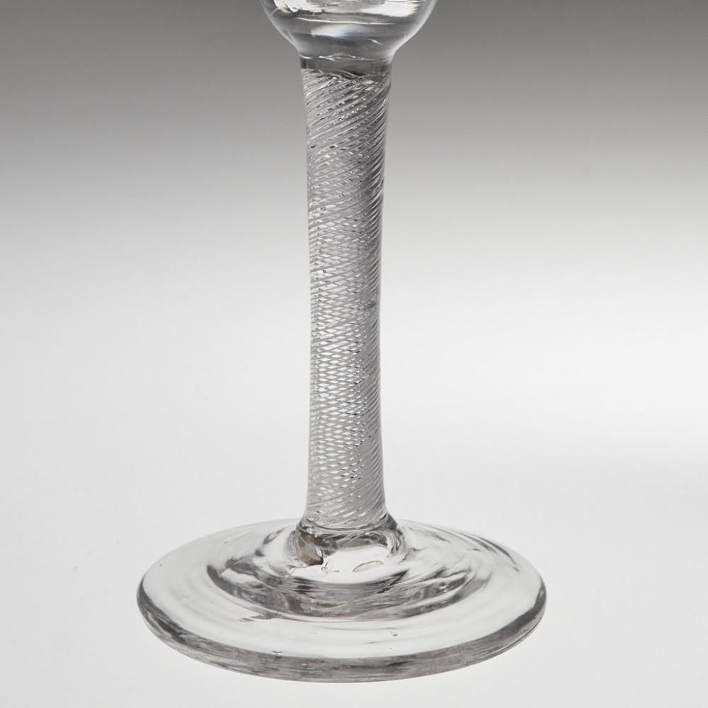 Heading : Petal moulded air twist stem Georgian wine glass
Period : George II - c1750
Origin : Engalnd
Colour : Clear
Bowl : Round funnel with petal moulding
Stem : Multi spiral air twist
Foot : Conical
Pontil : Snapped
Glass Type : Lead
Size : 
