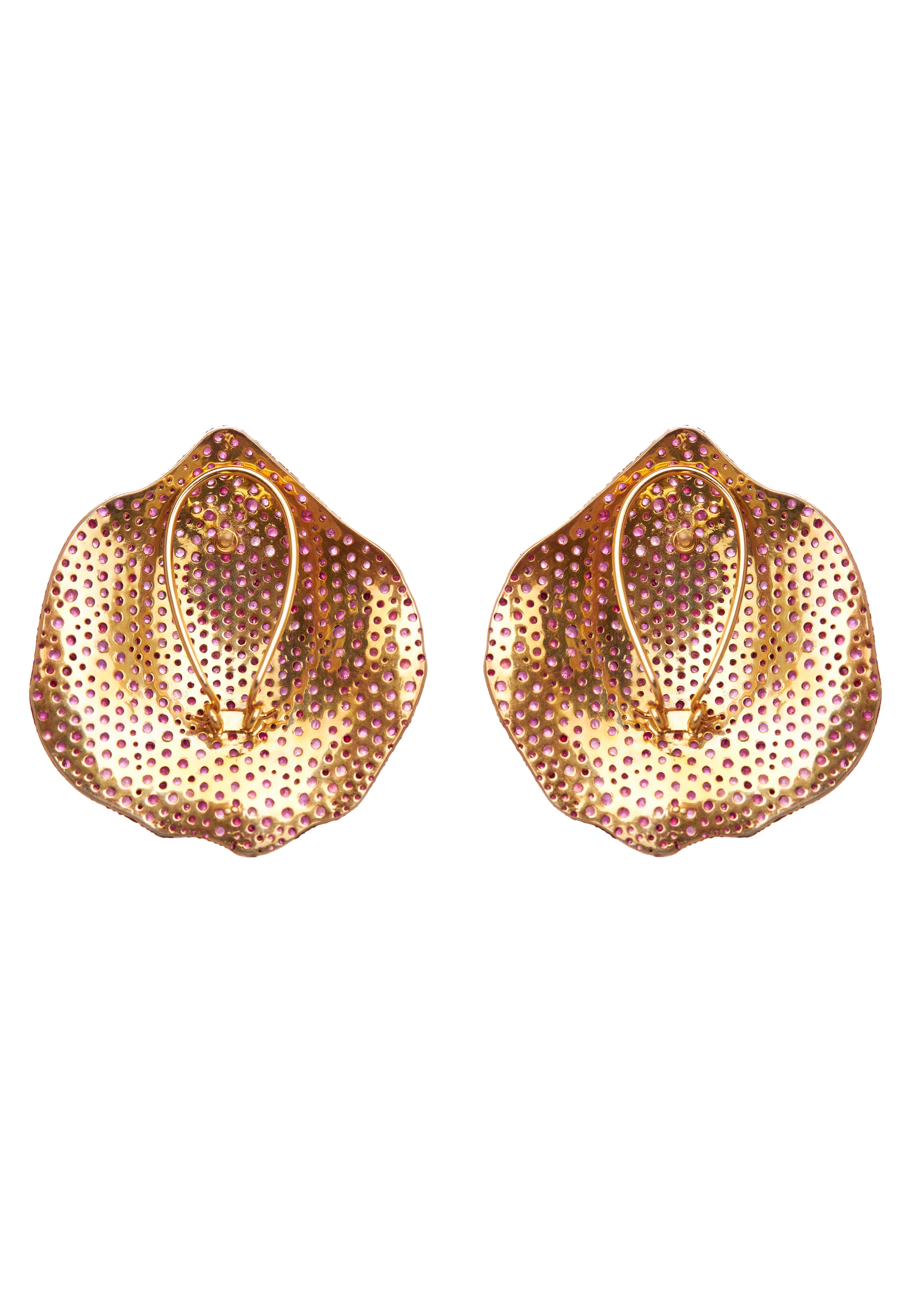 These mesmerizing Ruby Petal earrings from the Akasa Collection are a true celebration of nature’s beauty. Crafted in a unique petal-like shape, each earring is meticulously set with vibrant rubies totaling 20.45 carats, creating an enchanting
