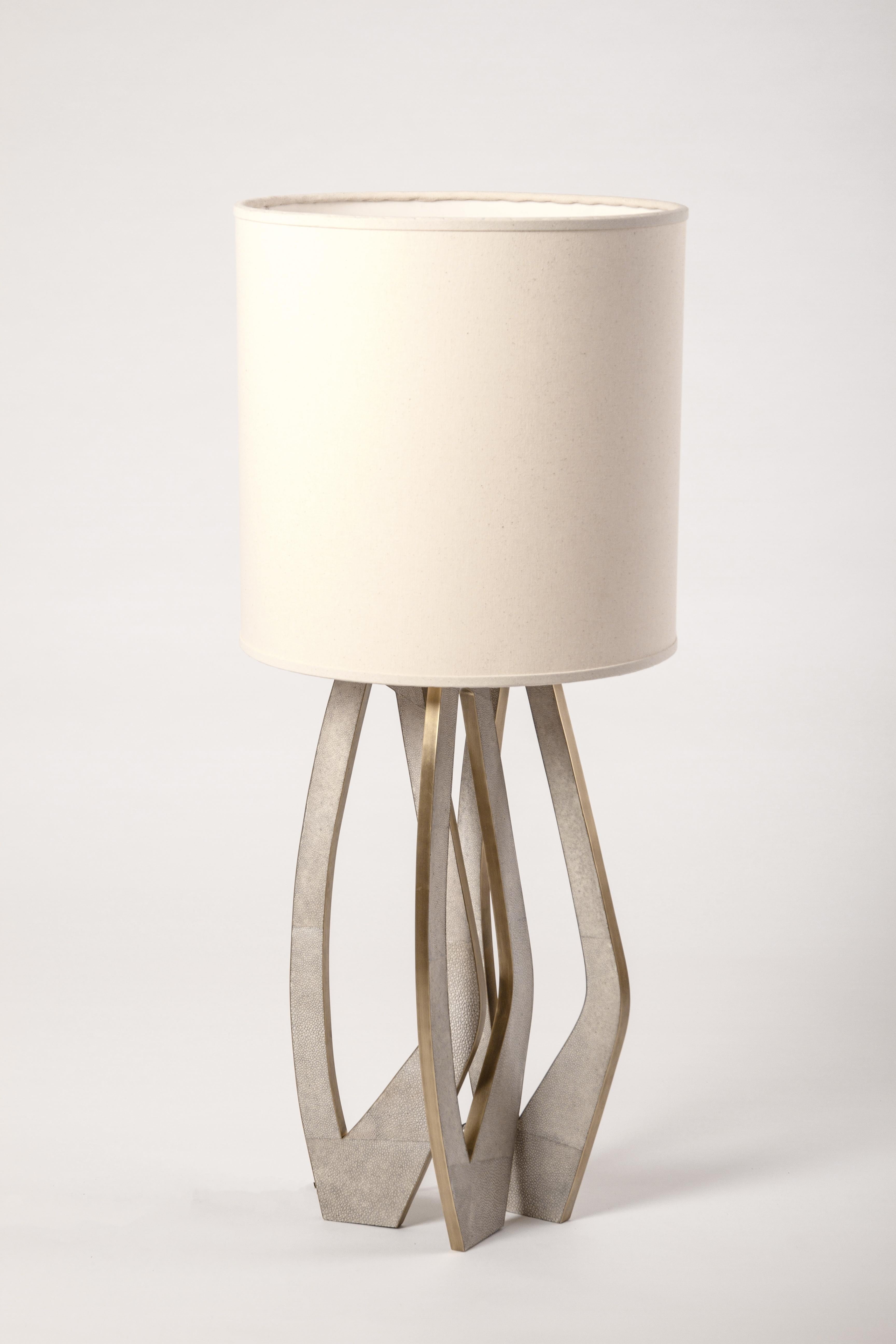 The Petal lamp inlaid in cream shagreen and bronze patina brass by R&Y Augousti is a beautiful piece with it’s intricate cutout detailing and inlaid legs. Shade included. Available in other finishes, see images at end of slide. 

The dimensions of