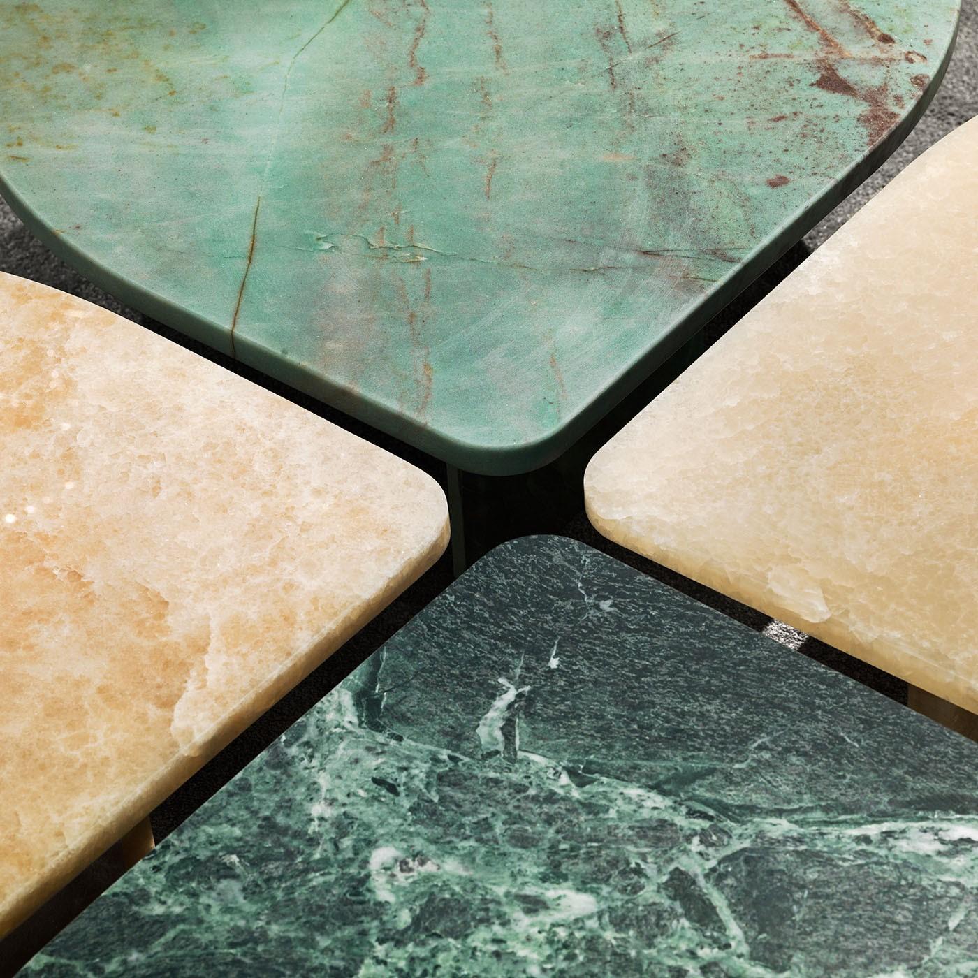 Romantic and sculptural thanks to its petal-shaped top, this coffee table offers an exclusive solution for complementing contemporary interiors seeking a dash of naturalistic inspiration. The entire structure, completed by a couple of thin slabs as