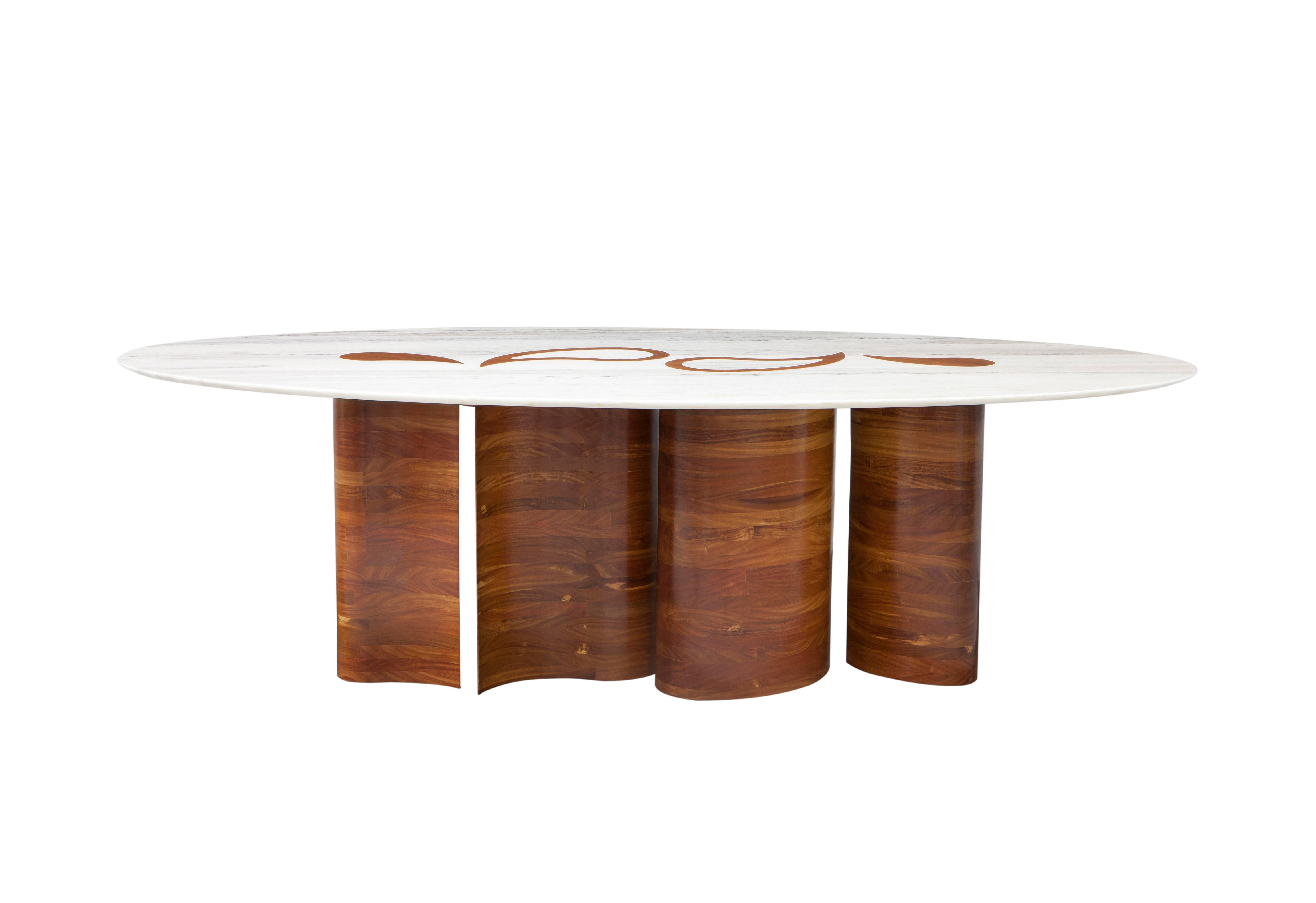 The brazilian solid cabreúva wood bases surpasses the champagne marble top and stands out on the surface of the table, creating an unexpected and sophisticated design and allowing the table to be used either alone, as a highlight in an entrance