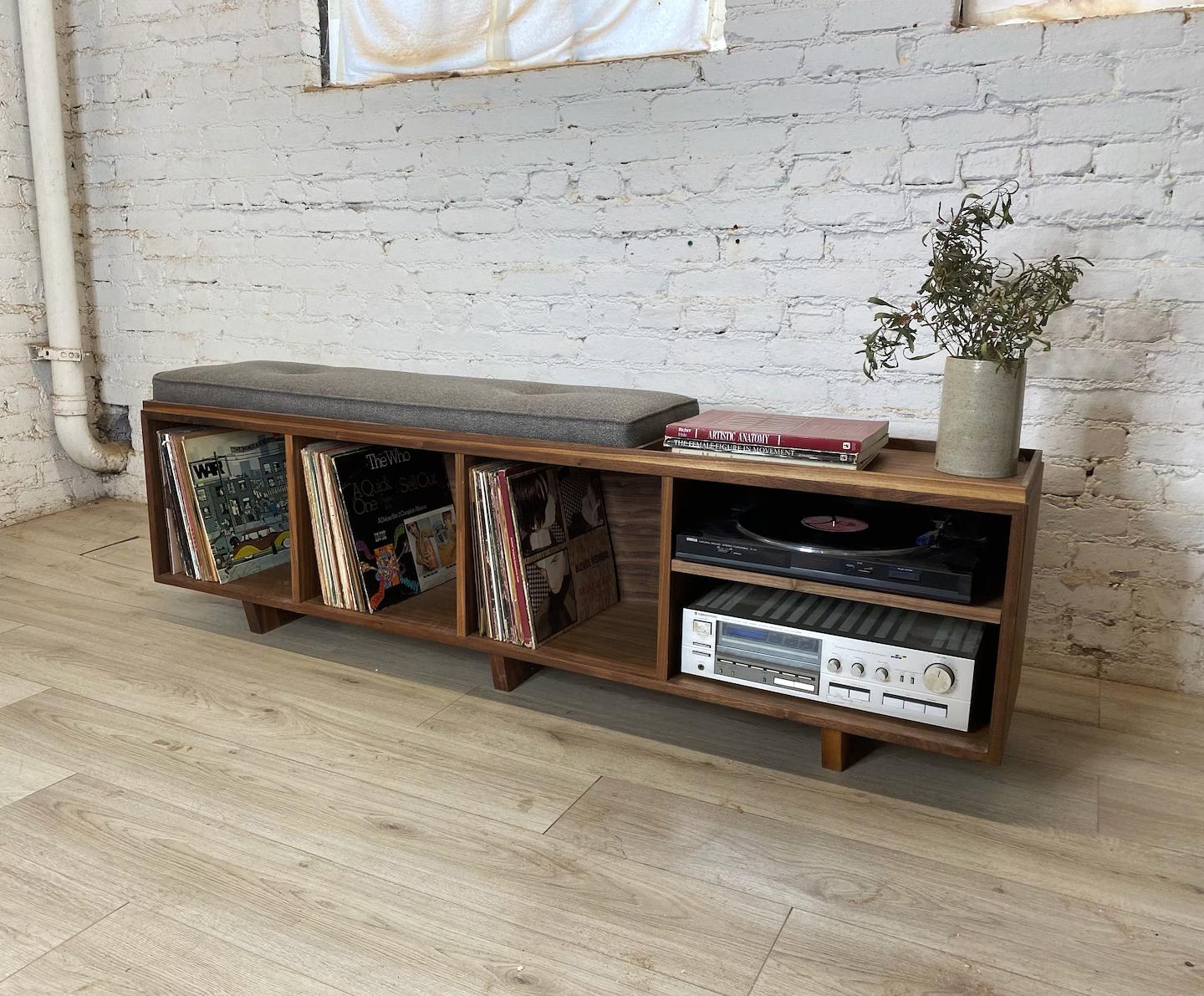 This bench is the ideal solution to having records sitting all over your house and no place to sit. This is an original design, but with a strong influence of Mid Century Danish Modern. The bench is roughly 67