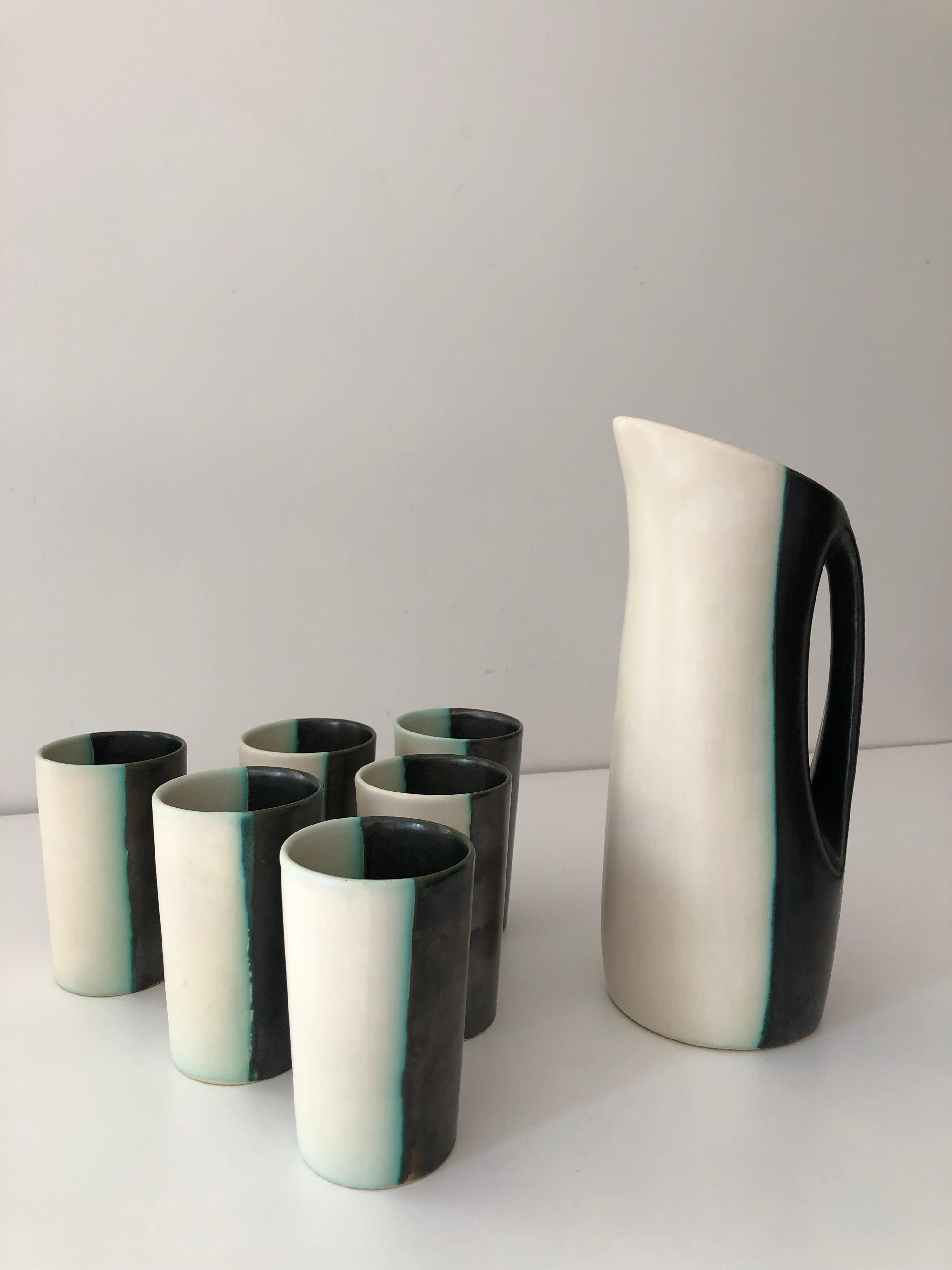 A midcentury glazed ceramic water pitcher set by Peter and Denise Orlando. Underside 