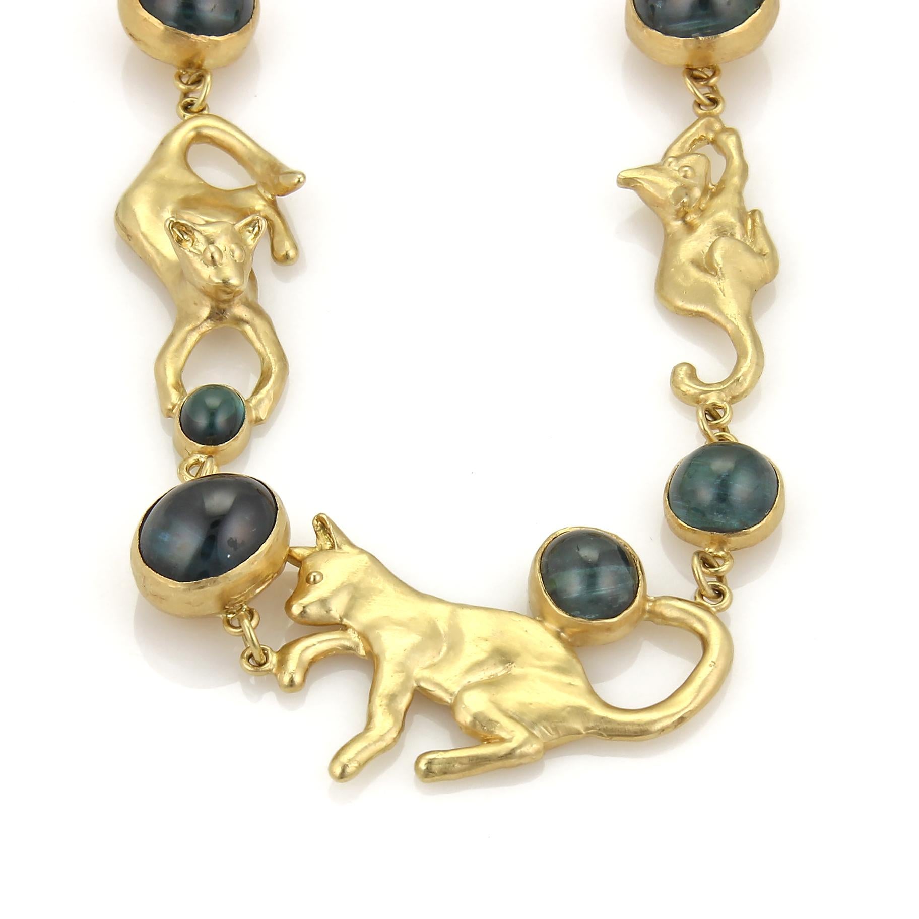 This in an impressive custom made adorable long necklace by Peter Aylen from the Aylen & Son Company , it is crafted from solid 18k yellow gold with a polished finish and has handmade full figure cats in various size, all in a playful position and
