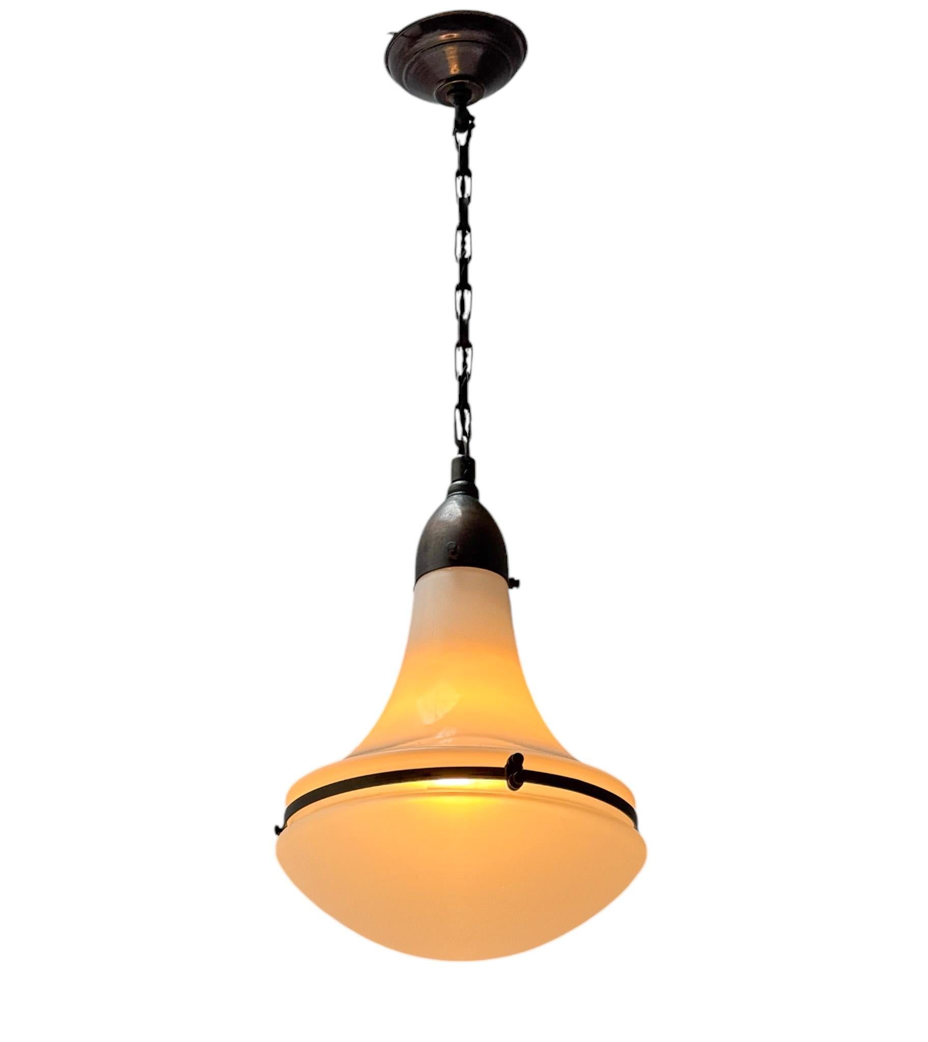 Stunning and elegant Art Nouveau pendant lamp.
Design by Peter Behrens for Siemens.
Striking German design from the 1900s.
Original patinated metal frame and chain with a brass finish and original etched glass shades.
Rewired with one original