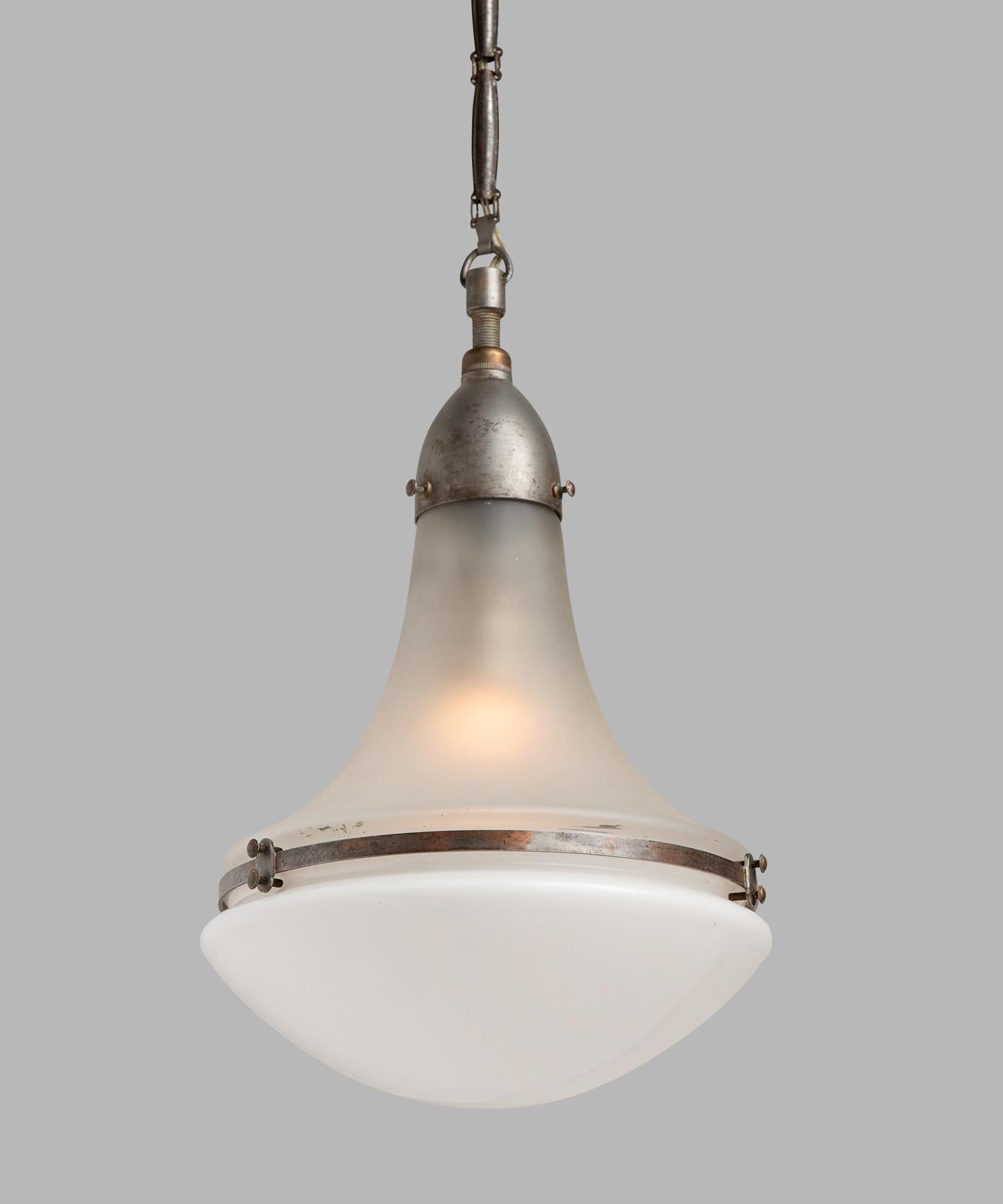 Peter Behrens Luzette pendant, Germany, circa 1920.

Small pendant with frosted glass top and opaline glass bottom, secured with copper fitter and brace. Manufactured by AEG Siemens with manufacturer's mark.