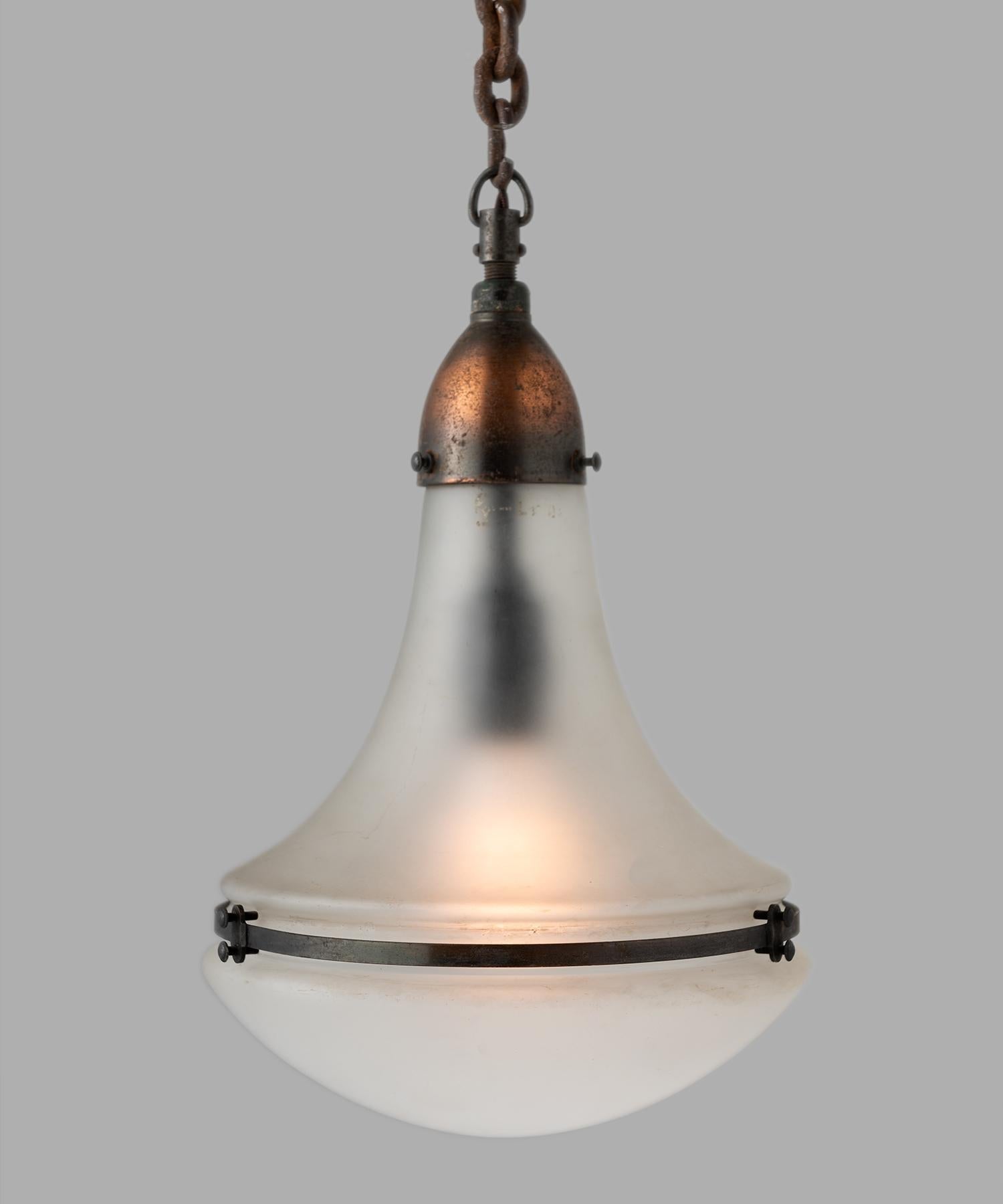 Peter Behrens Luzette pendants, Germany, circa 1930.

Frosted glass shades, secured with copper fitter and brace.