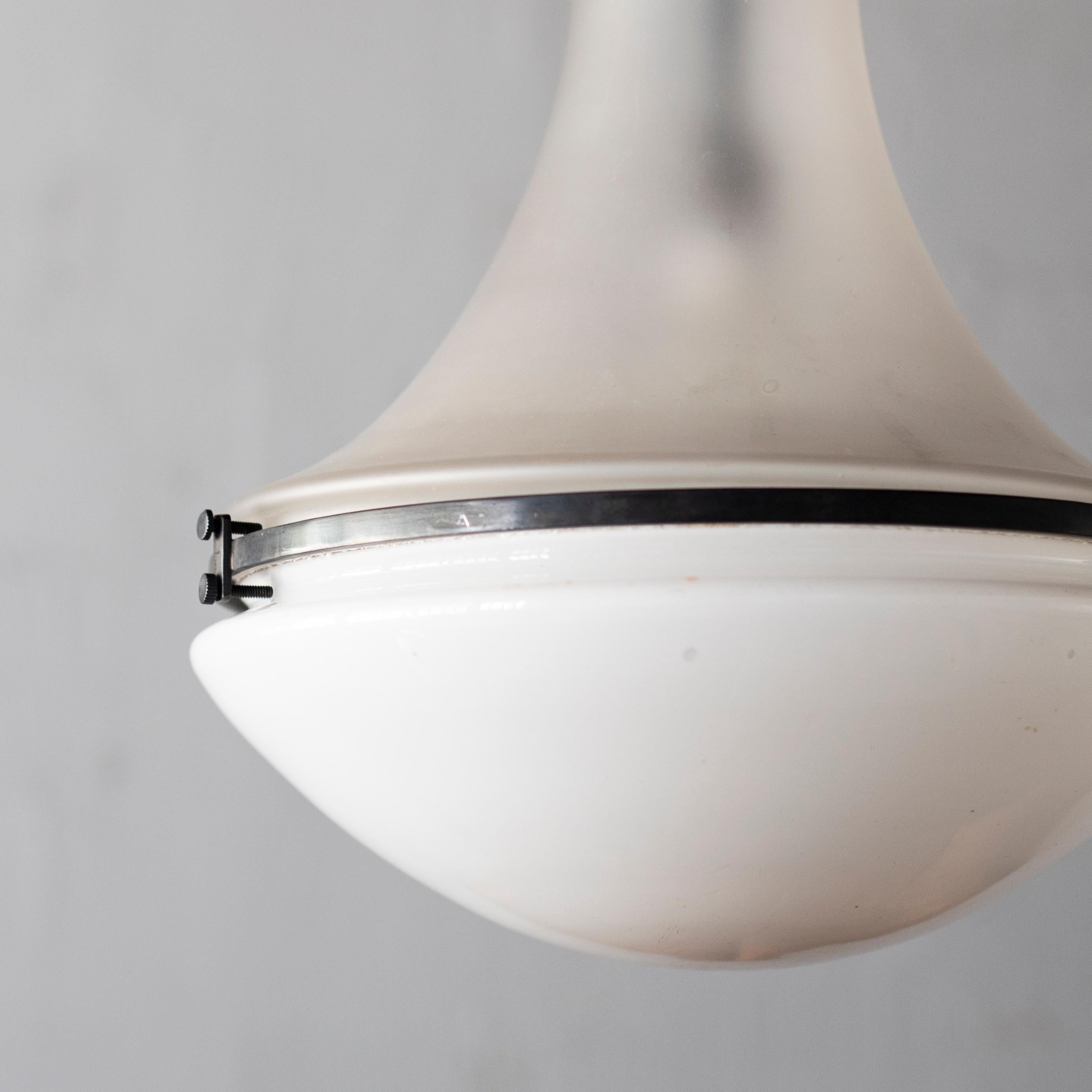 Luzette pendant lamp by Peter Behrens. 
This product was produced for Seamens and used in public buildings such as stations in the early 1900s. The top and bottom parts of milky glass and frosted glass are united with a metal rim and screws,