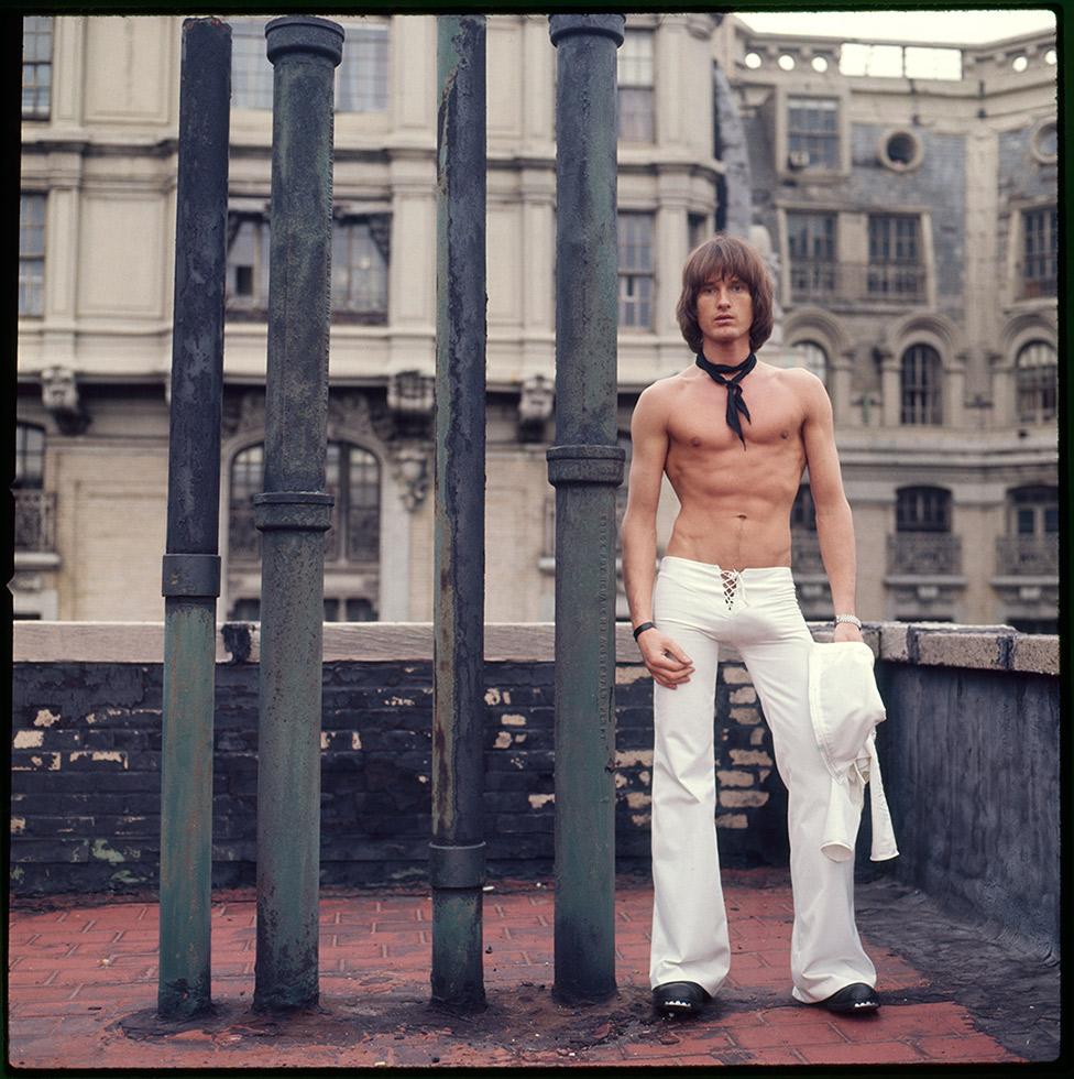 Peter Berlin Color Photograph - Self Portrait on the Roof of the Ansonia (White Pants)