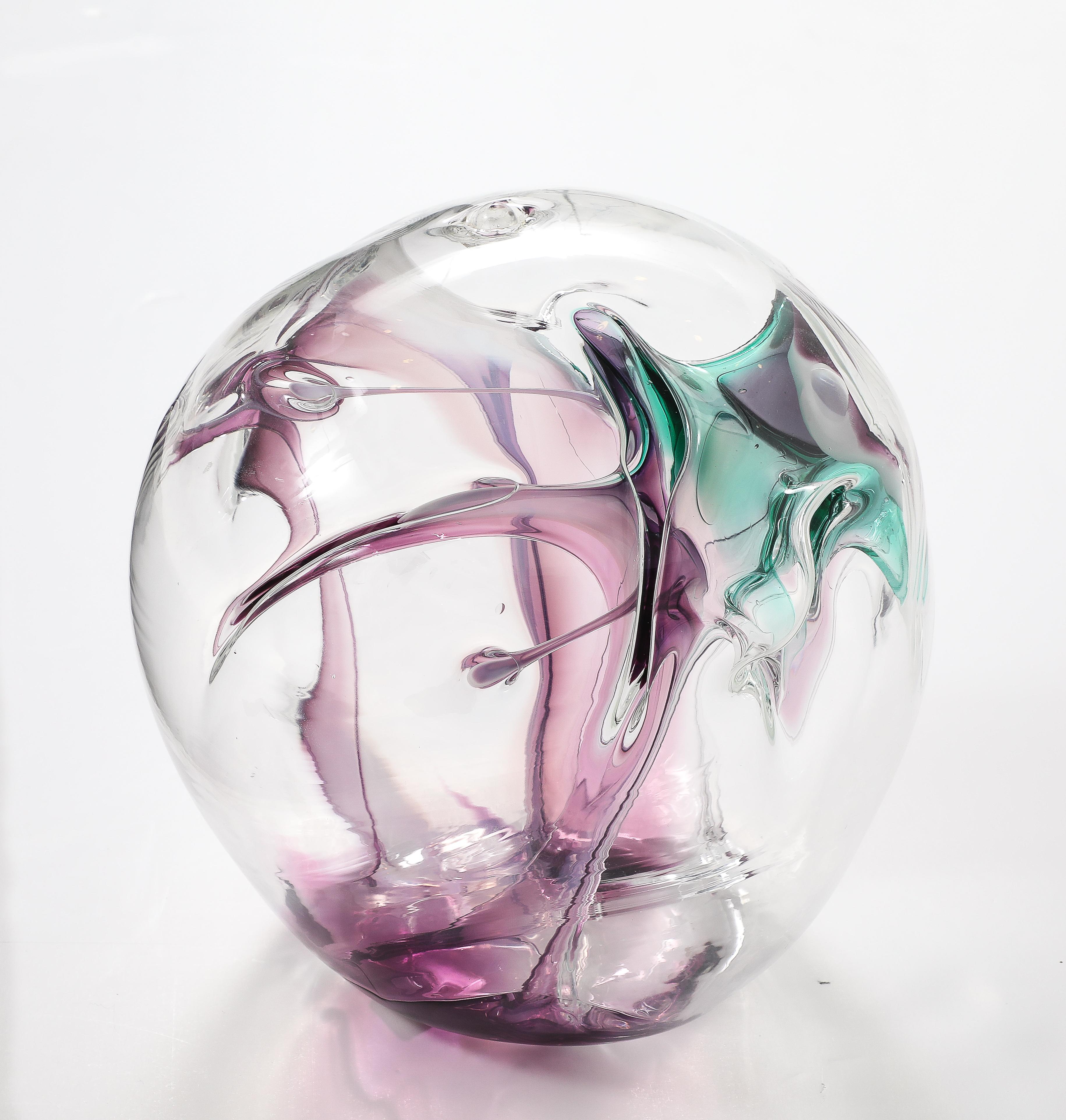 Wonderful hand blown glass Orb sculpture signed and dated by PETER BRAMHALL 1998.
The Orb has internal glass threads in beautiful shades of Magenta and Green.
Please see All our other Bramhall's listed to create a stunning collection.