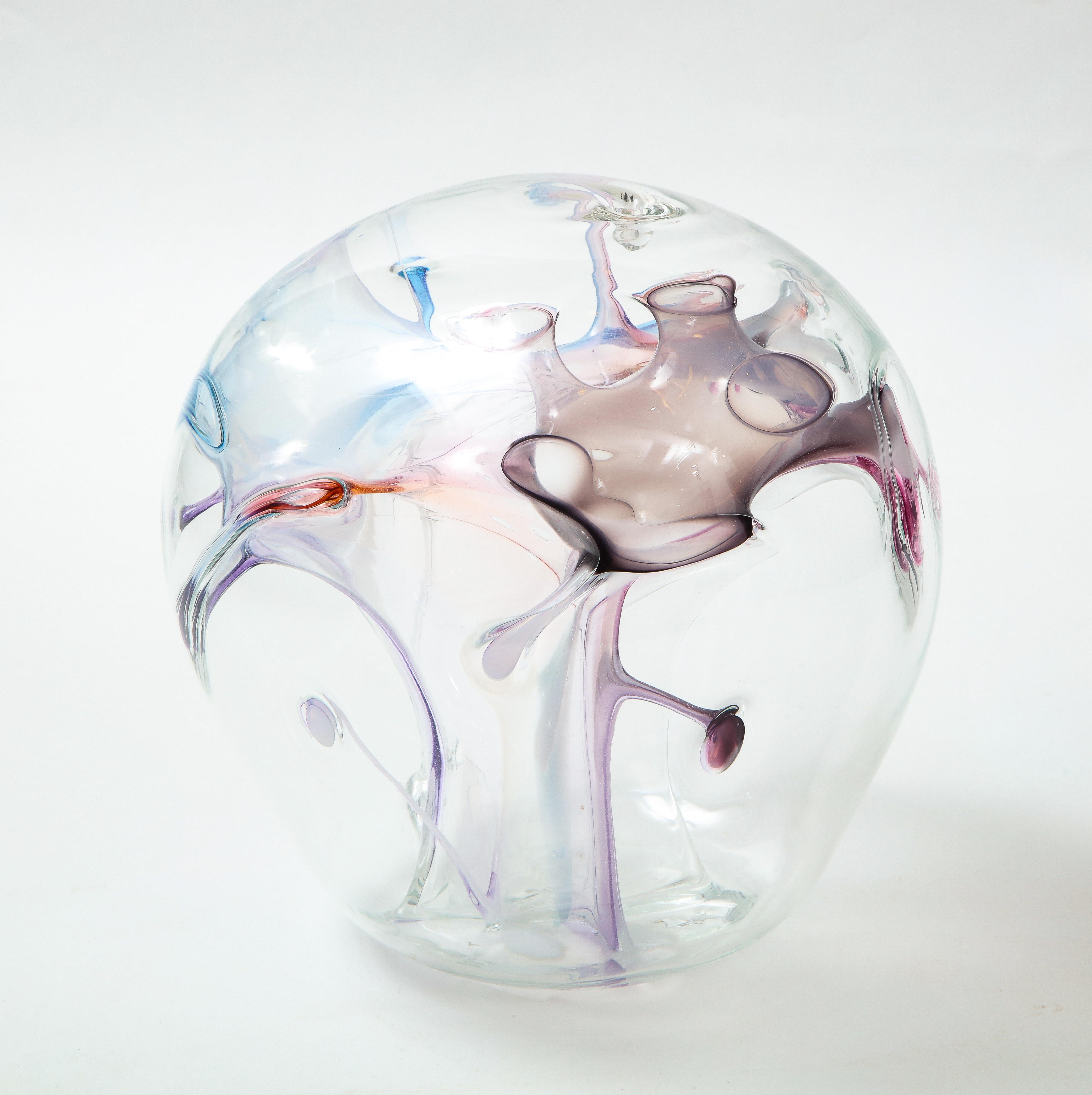 Handblown glass Orb sculpture with internal glass threads in pastel colors.
It is signed and dated on the bottom Peter Bramhall 1987.