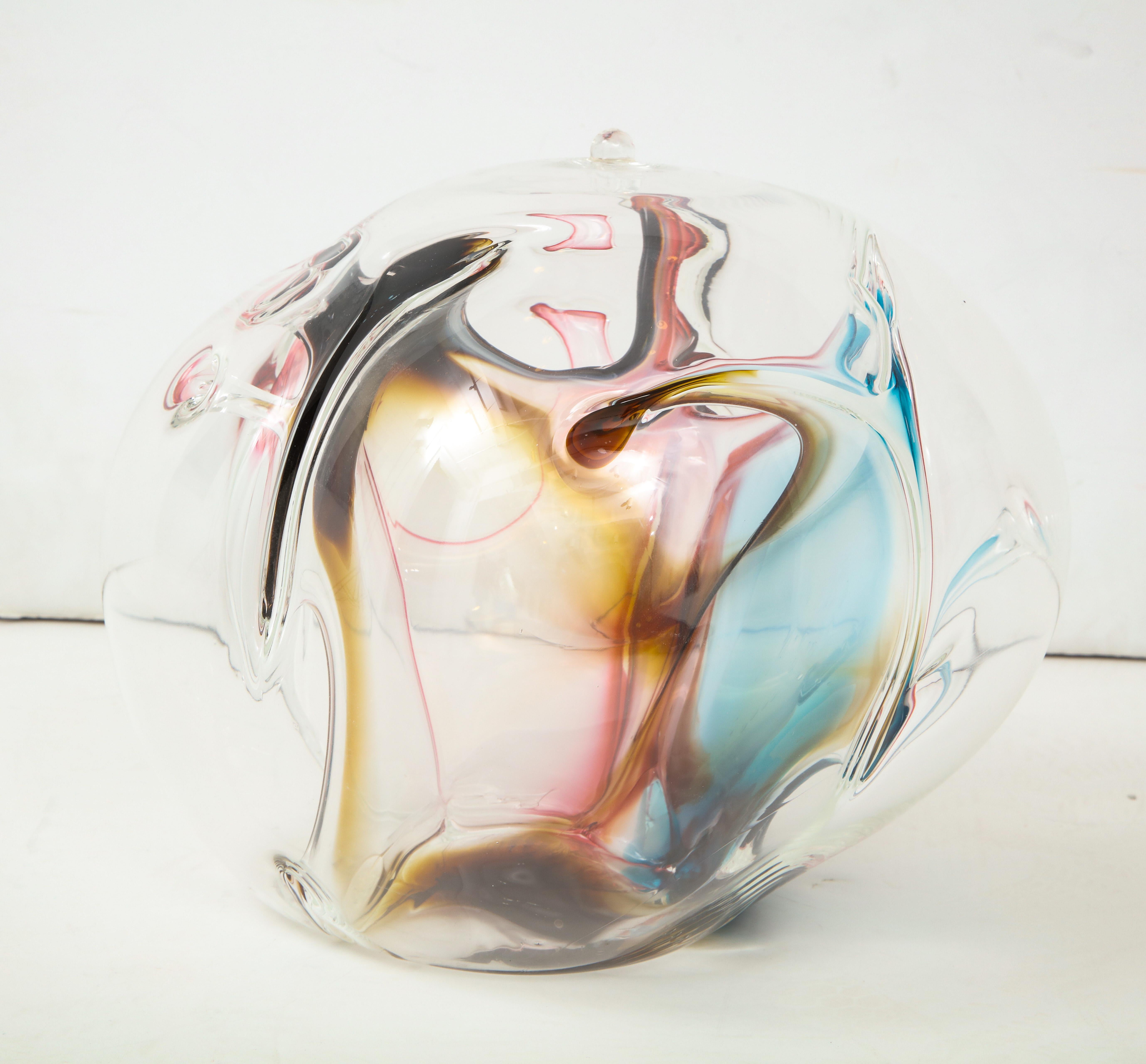 Multi-color hand blown glass orb sculpture with internal threads of blue, rose, amber and dark brown. Signed on bottom.