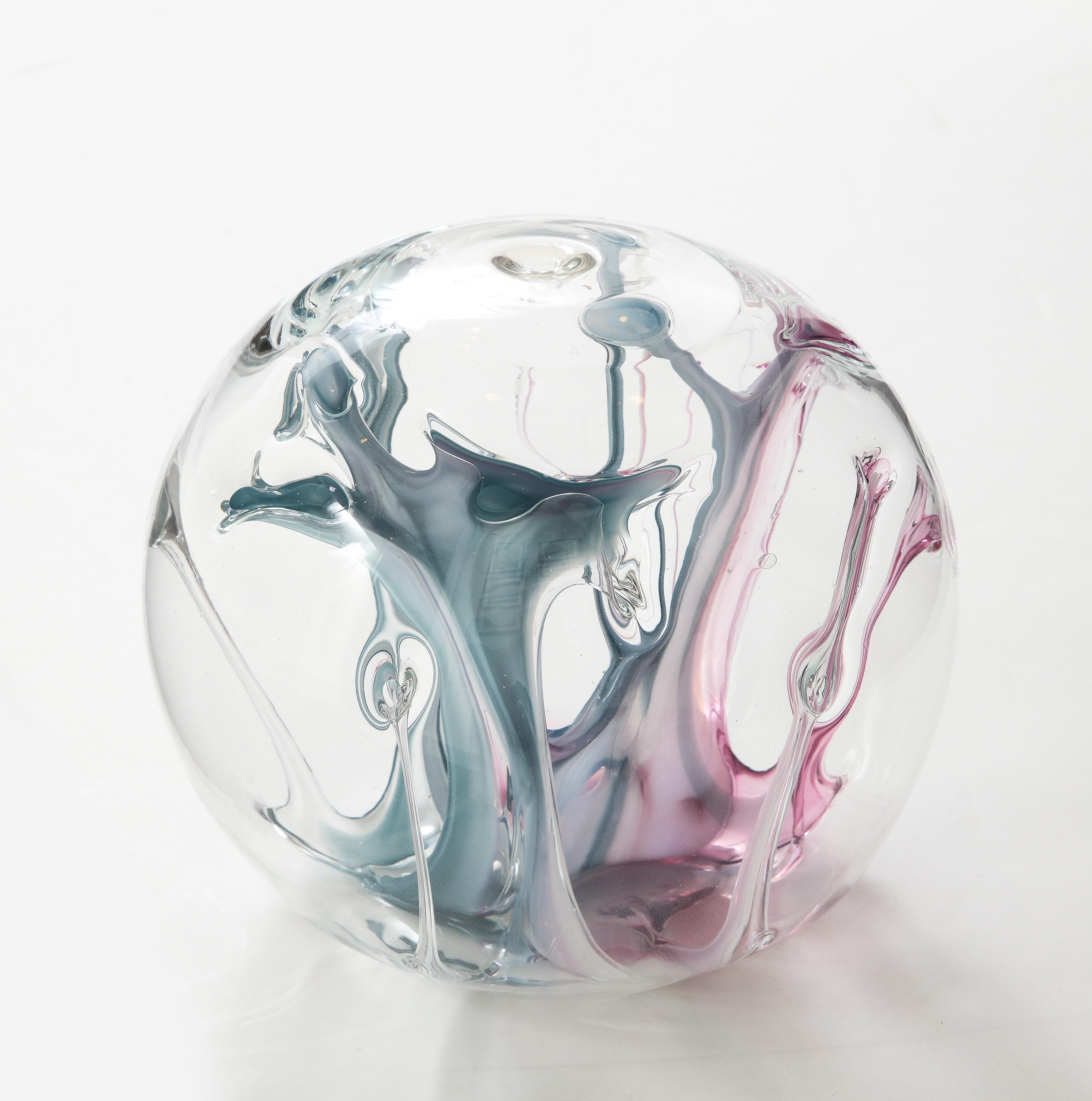 Spectacular mouth blown glass orb sculpture with internal magenta and petrol blue glass threads. Signed on bottom, Peter Bramhall.