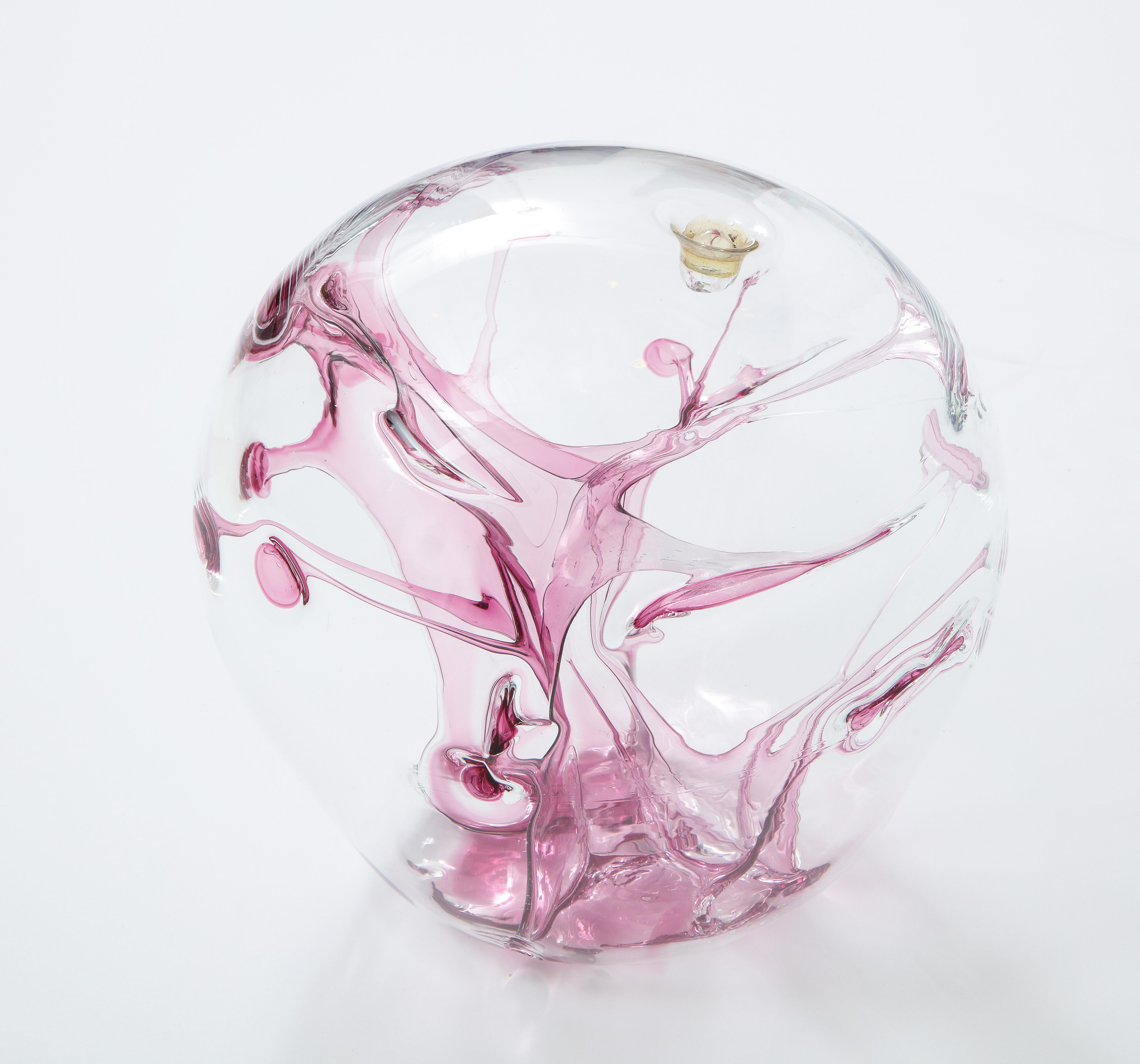 Modernist blown glass sculpture with internal magenta glass threads. Signed.