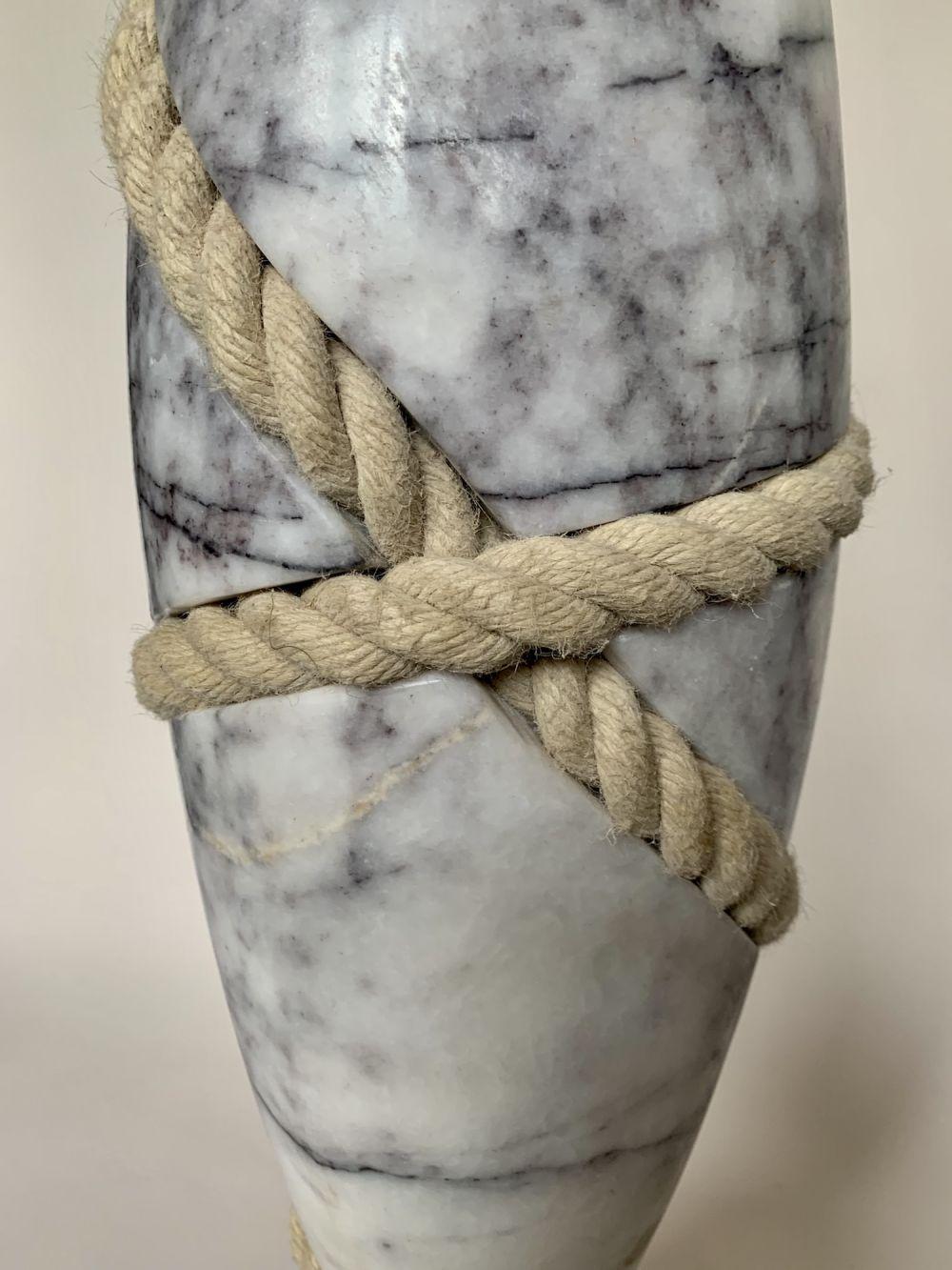 Lilac marble, oak, rope. Dimensions : 74 cm × 20 cm × 16 cm
Unique work delivered with a certificate of authenticity. 
Peter Brooke-Ball's works surprise with their humour, simplicity and sensuality. As he himself states, the desire is to create
