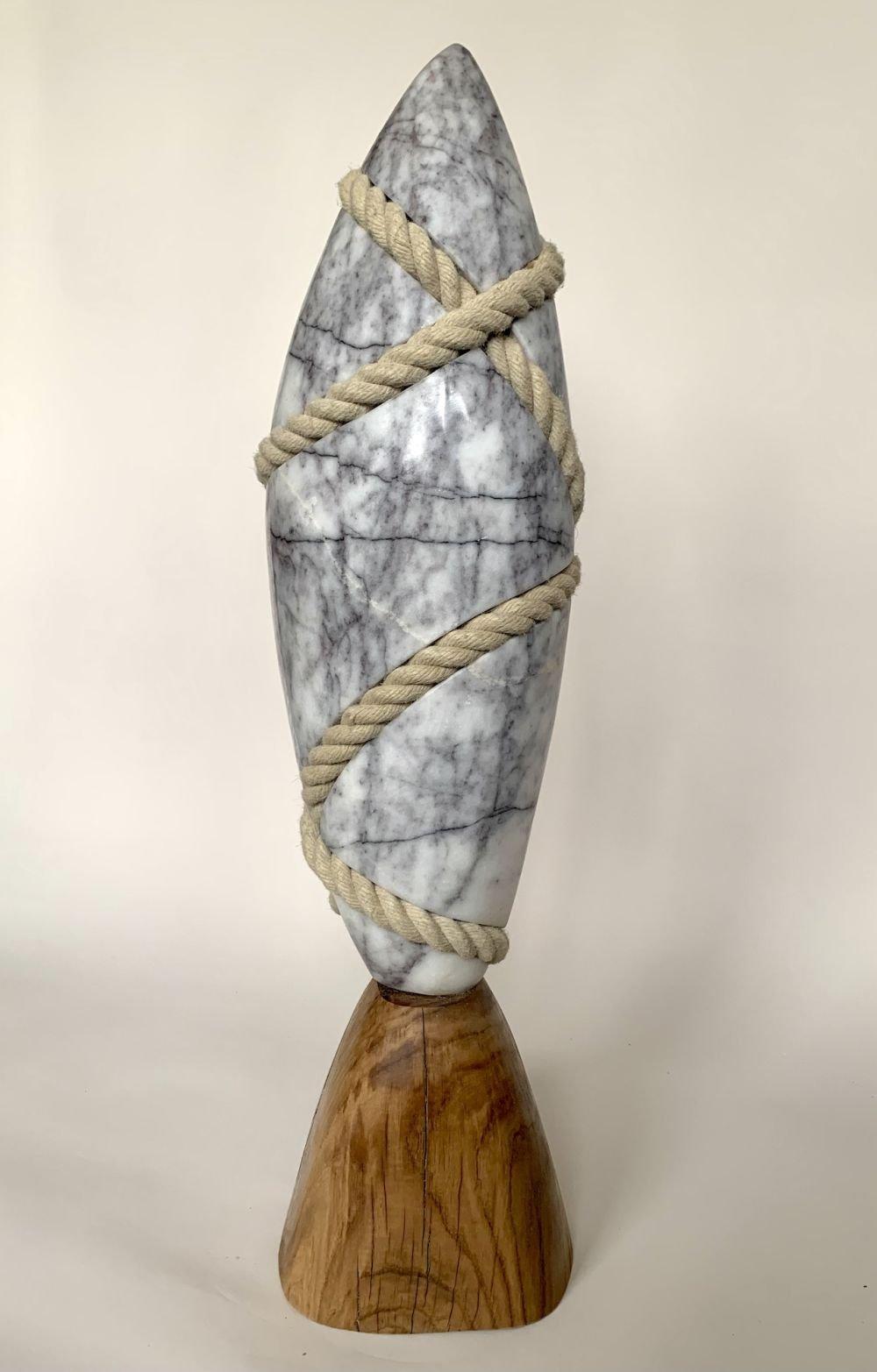 Aspiration is a stone sculpture by contemporary British artist Peter Brooke-Ball. This contemporary sculpture is a piece of Lilac marble surrounded by a hanging cotton rope.
In this work, the artist initiates a visual dialogue between two materials
