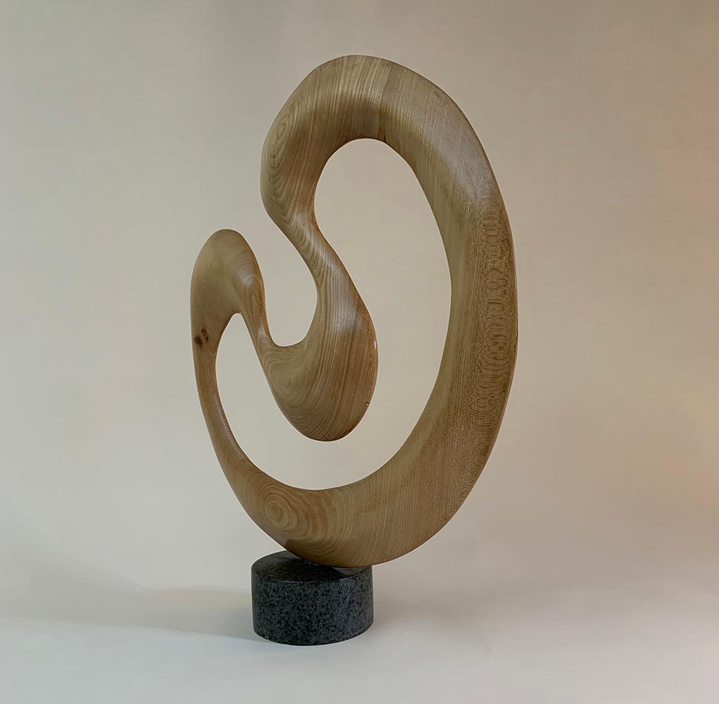 Ash wood on Polyphant stone, 52 cm × 45 cm × 12 cm.
The dimensions include the base, which is attached (diameter 10 cm, height: 8 cm).
Unique work delivered with a certificate of authenticity. 
Peter Brooke-Ball's works surprise with their humour,