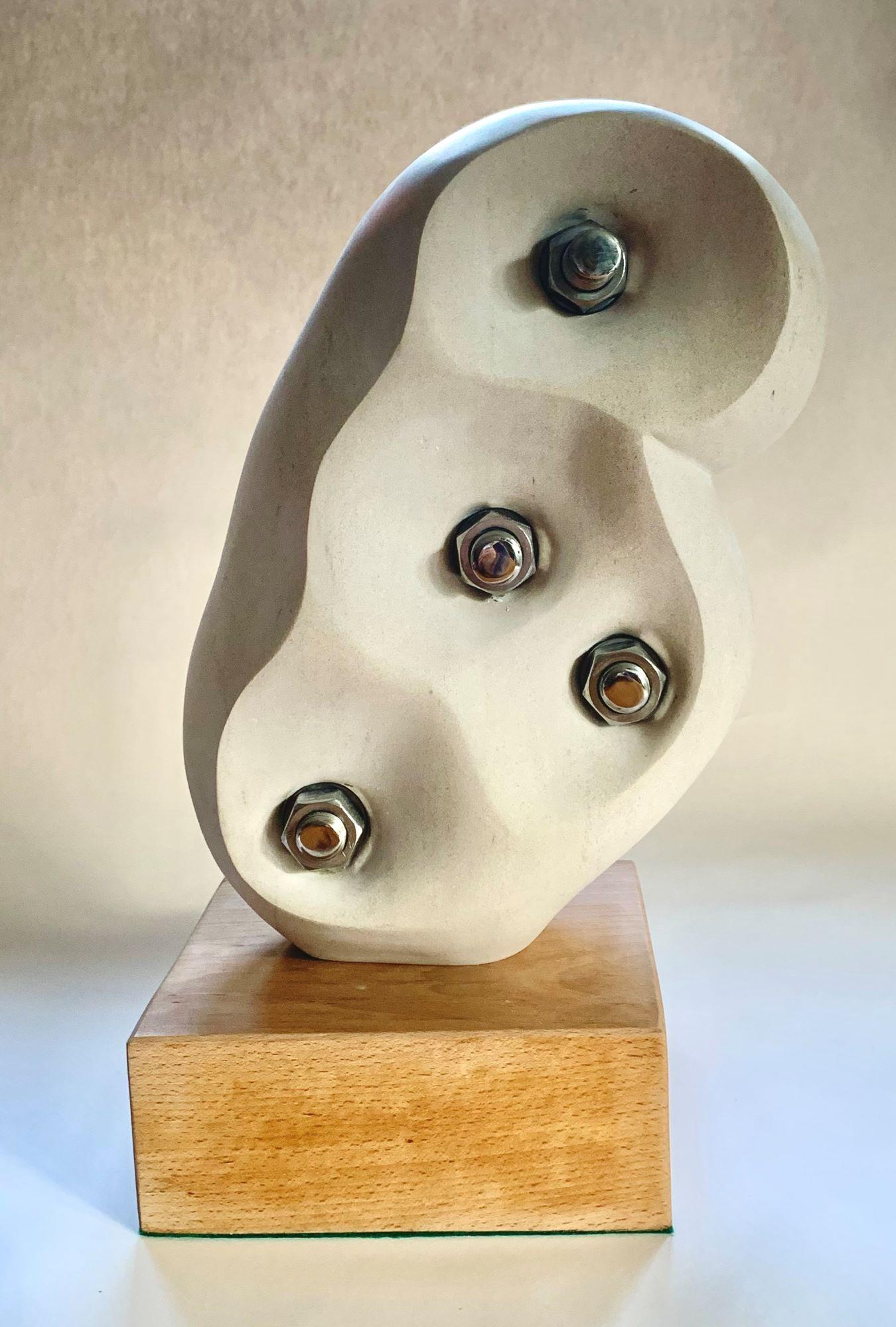 Without Bonds is a unique Portland limestone, stainless steel on beech wood base sculpture by contemporary artist Peter Brooke-Ball, dimensions are 51 × 26 × 20.5 cm (20.1 × 10.2 × 8.1 in).  
The sculpture comes with a certificate of