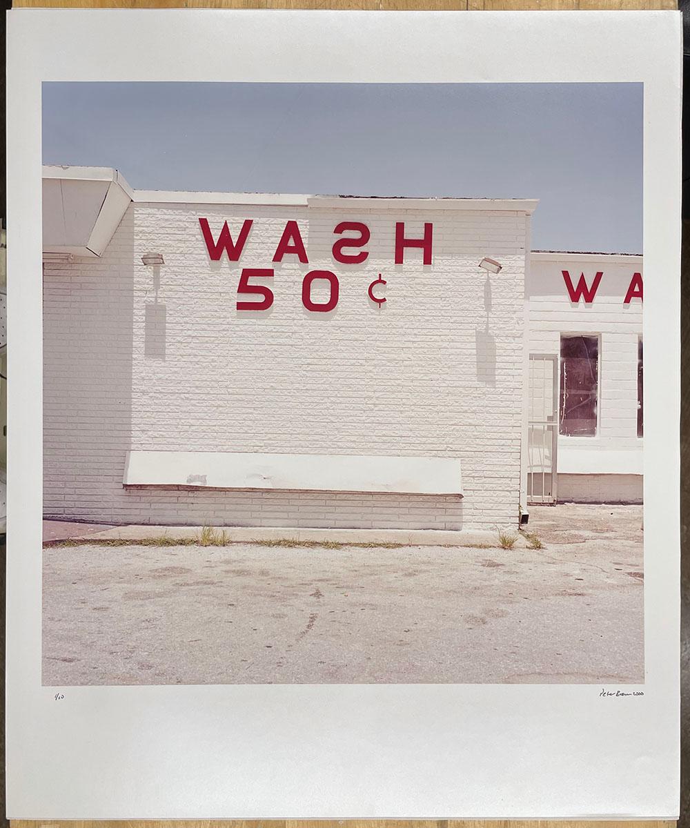 Wash 50 cents - Glaveston Bay, Texas, white building with red text, architecture - Photograph by Peter Brown