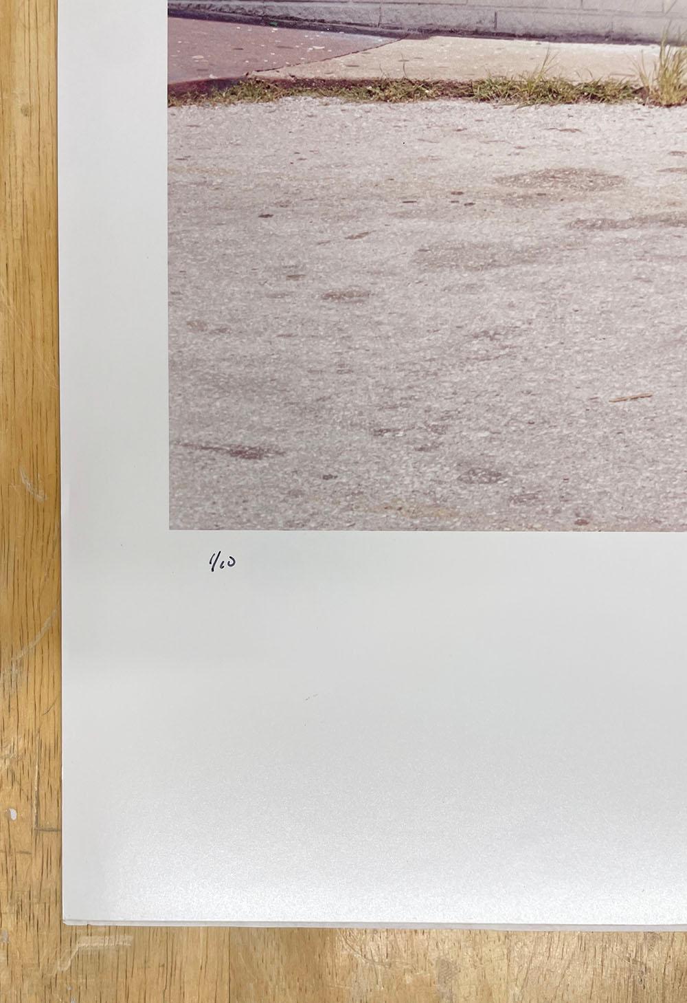 Wash 50 cents - Glaveston Bay, Texas, white building with red text, architecture - Contemporary Photograph by Peter Brown