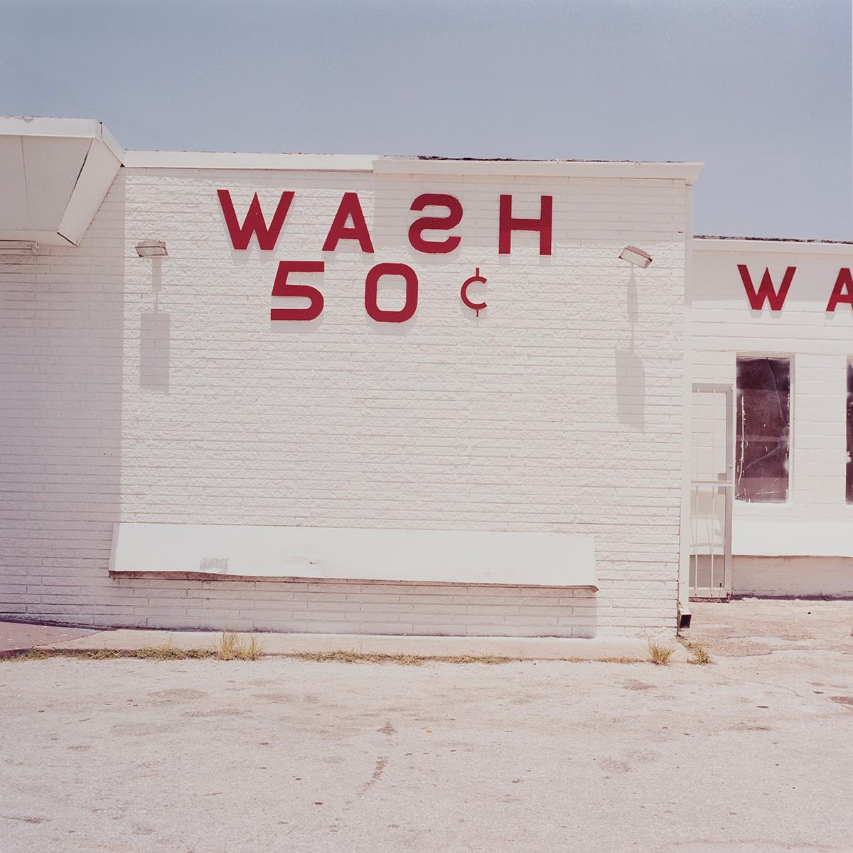 Peter Brown Color Photograph - Wash 50 cents - Glaveston Bay, Texas, white building with red text, architecture