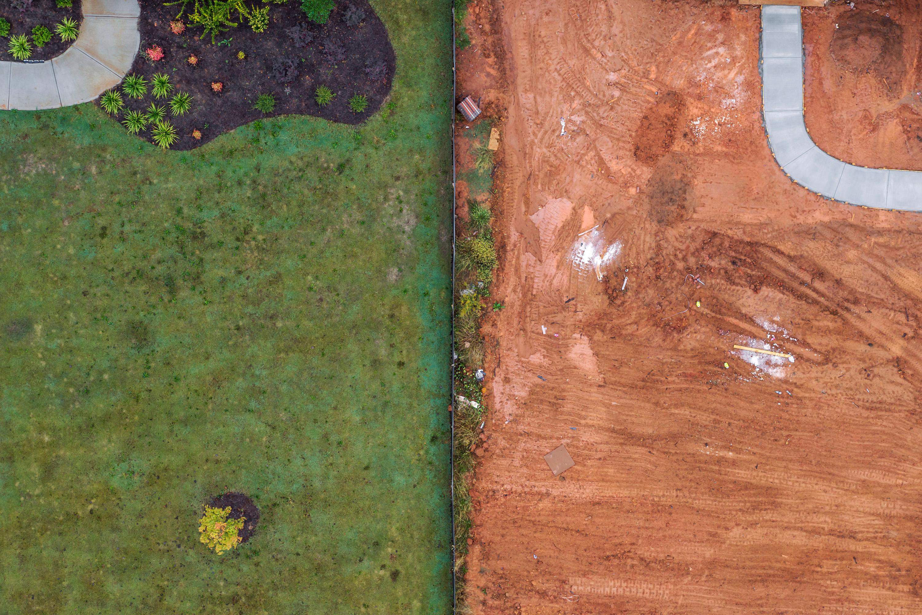 "Construction Site, Mountain Park, Georgia #1, 2019" is a drone photograph featuring hues of red, orange, green and grey. Edition of 5. This photograph may be available in additional sizes. Peter Essick is inspired by the work of Walker Evans, Ray