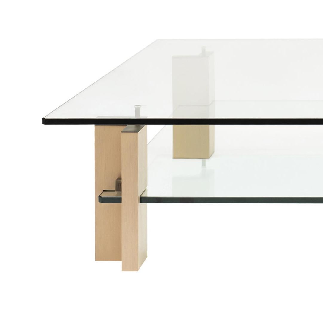 Designed by Peter Ghyczy 2001.
Manufactured by Ghyczy (Netherlands)

Architectural aesthetics build the main element of this coffee table. A strong base made of tempered glass and wood radiates stability while yet again the top glass plate seems