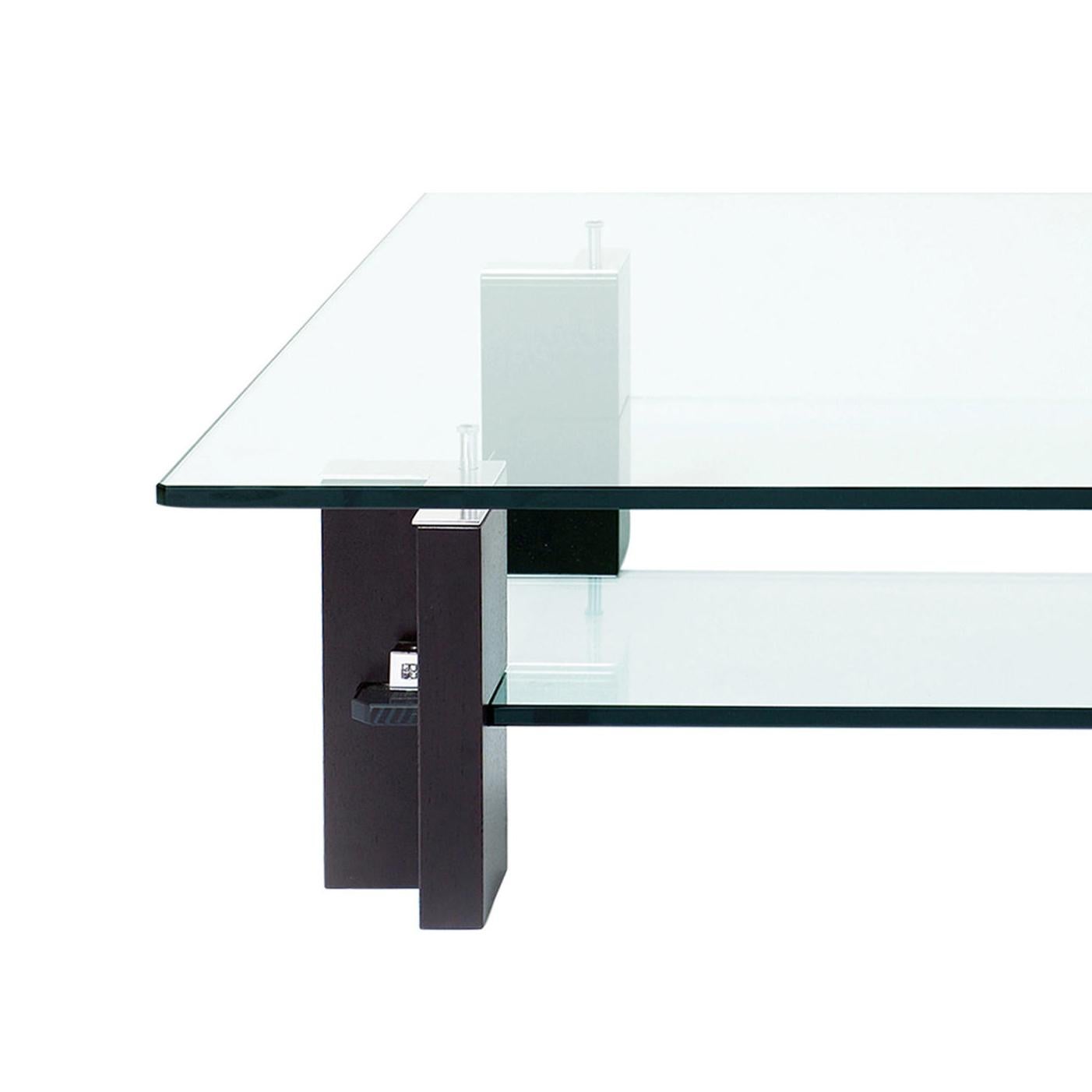 Designed by Peter Ghyczy 2001.
Manufactured by Ghyczy (Netherlands)

Architectural aesthetics build the main element of this coffee table. A strong base made of tempered glass and wood radiates stability while yet again the top glass plate seems