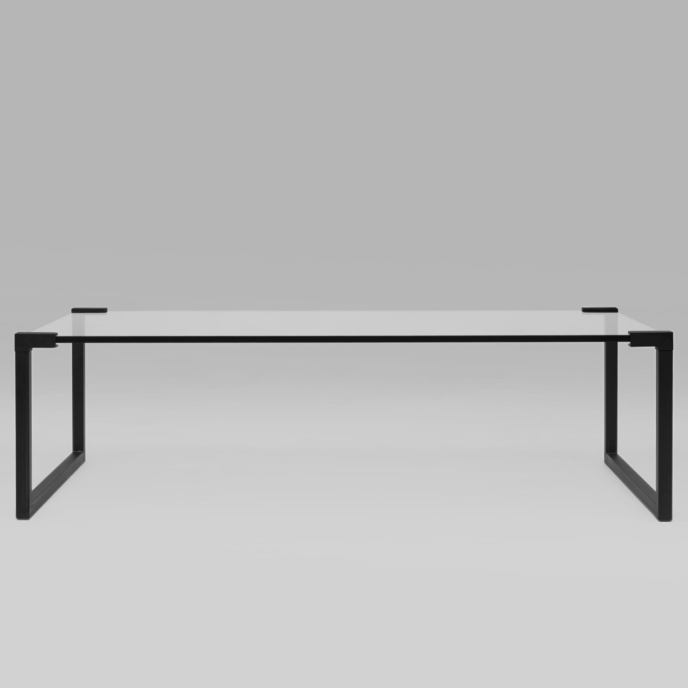 Contemporary coffee table designed by Peter Ghyczy.
Manufactured by Ghyczy (Netherlands)

The twin frames are constructed of 3 × 3 square tubes and secured to the tabletop by cast metal details. The 15 mm glass top is available in clear, optiwhite