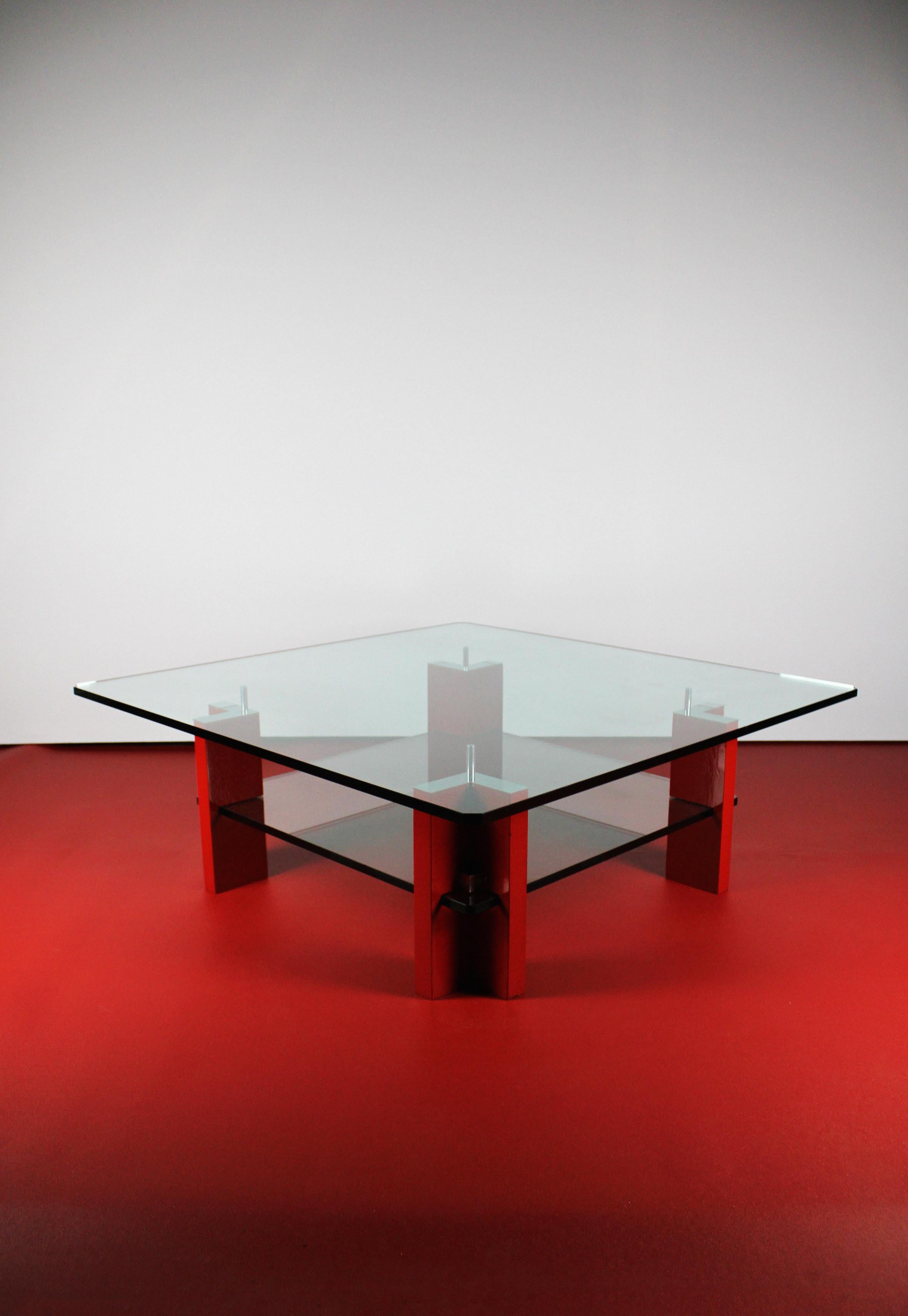 Presenting the Peter Ghyczy T 57 D, a distinctive modern coffee table that stands as a rare creation with only a few versions in existence. The timeless aesthetic is achieved through the unique combination of smoked glass and vibrant red wood legs.