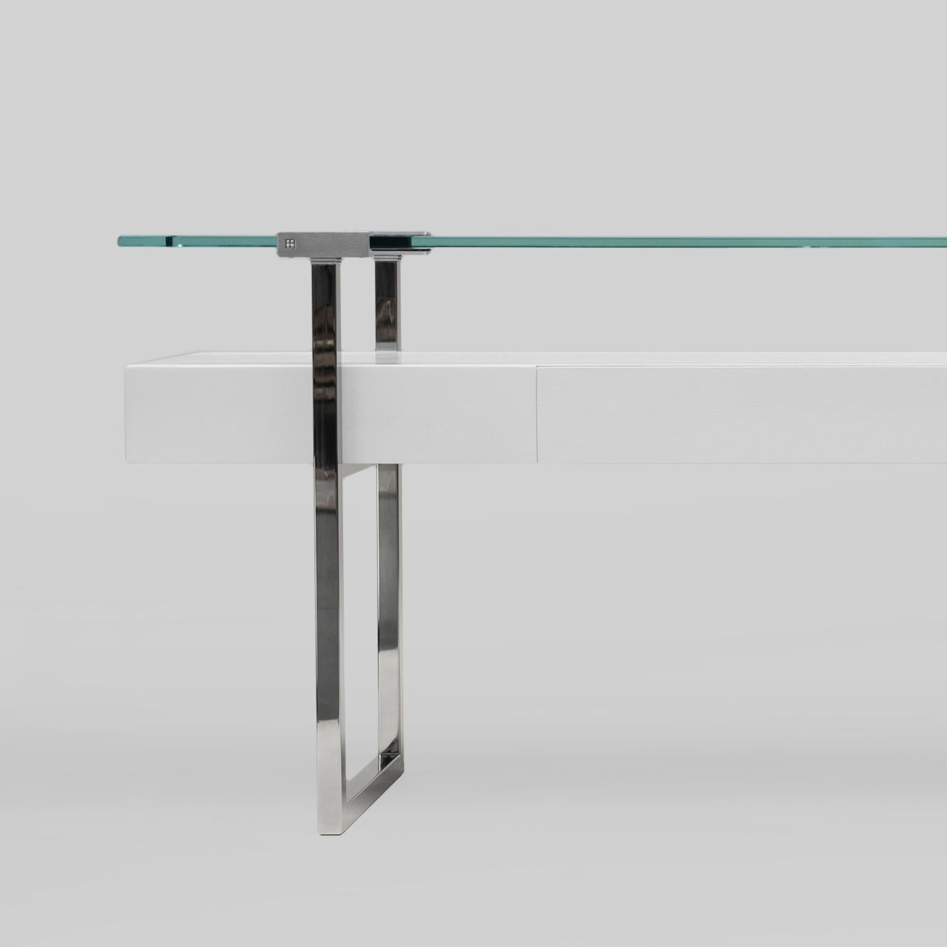 Console table designed by Peter Ghyczy in 2009.
Manufactured by Ghyczy, (Netherlands)

The twin frames are constructed of 3 × 3 square tubes and secured to the tabletop by cast metal details. Special feature is a solid wooden drawer. The strong