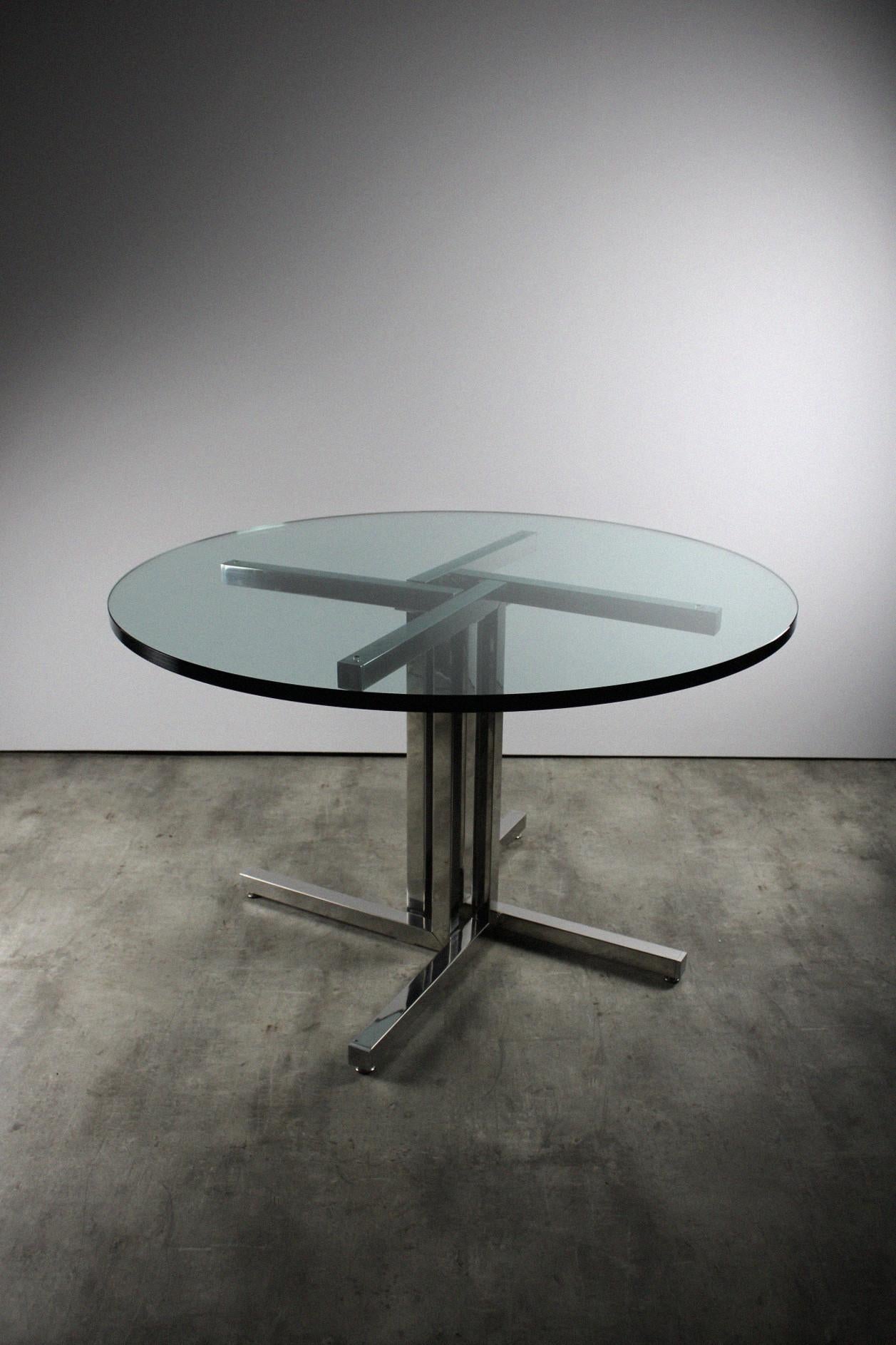 This dining table by Peter Ghyczy, is a unique piece where only one version was made. The combination of the smoked glass and chrome frame, instantly create a timeless appearance. Peter Ghyczy designed this model as a prototype and had this great