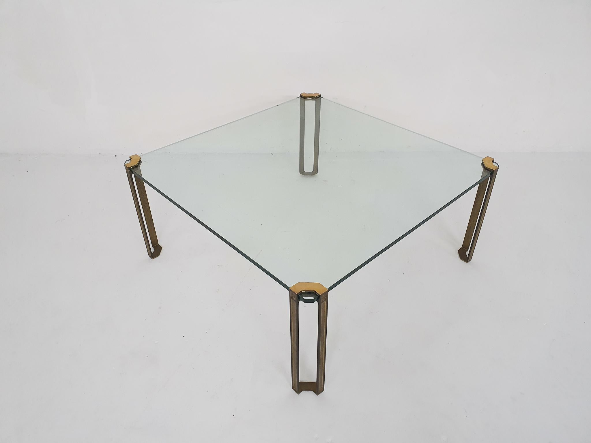 Square coffee table by Peter Ghyczy. Solid brass legs and a thick glass plate.
Architect and designer Peter Ghyczy, born in Hungary in 1940, graduated at the Technical University of Aachen. His most successful design was the Garden Egg Chair in