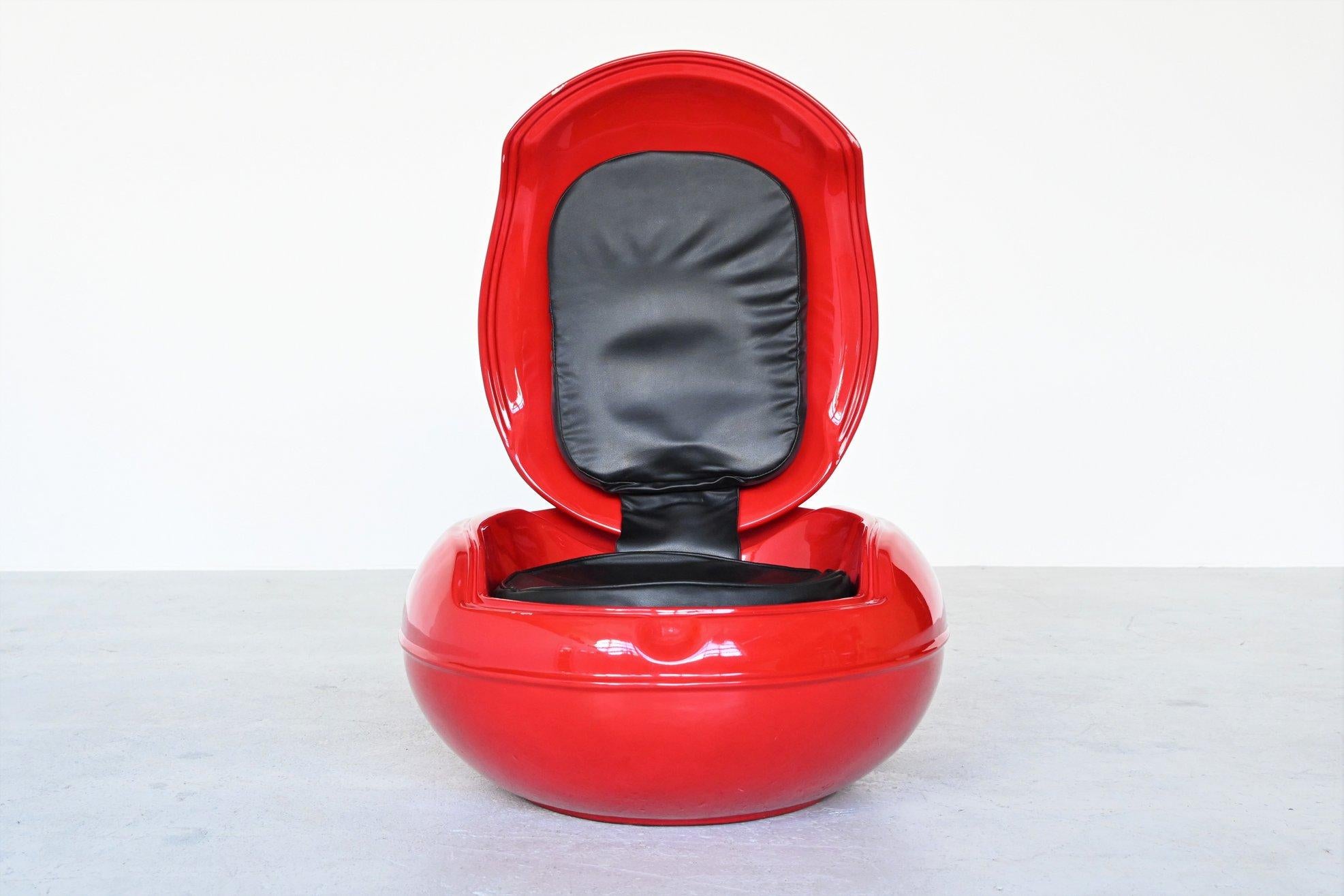 Iconic red garden Senftenberg egg chair designed by Peter Ghyczy, Germany, 1968. This collectable egg chair was the first chair in the world that is made of polyurethane. The seat is made of black leather. It’s completely waterproof when flipping