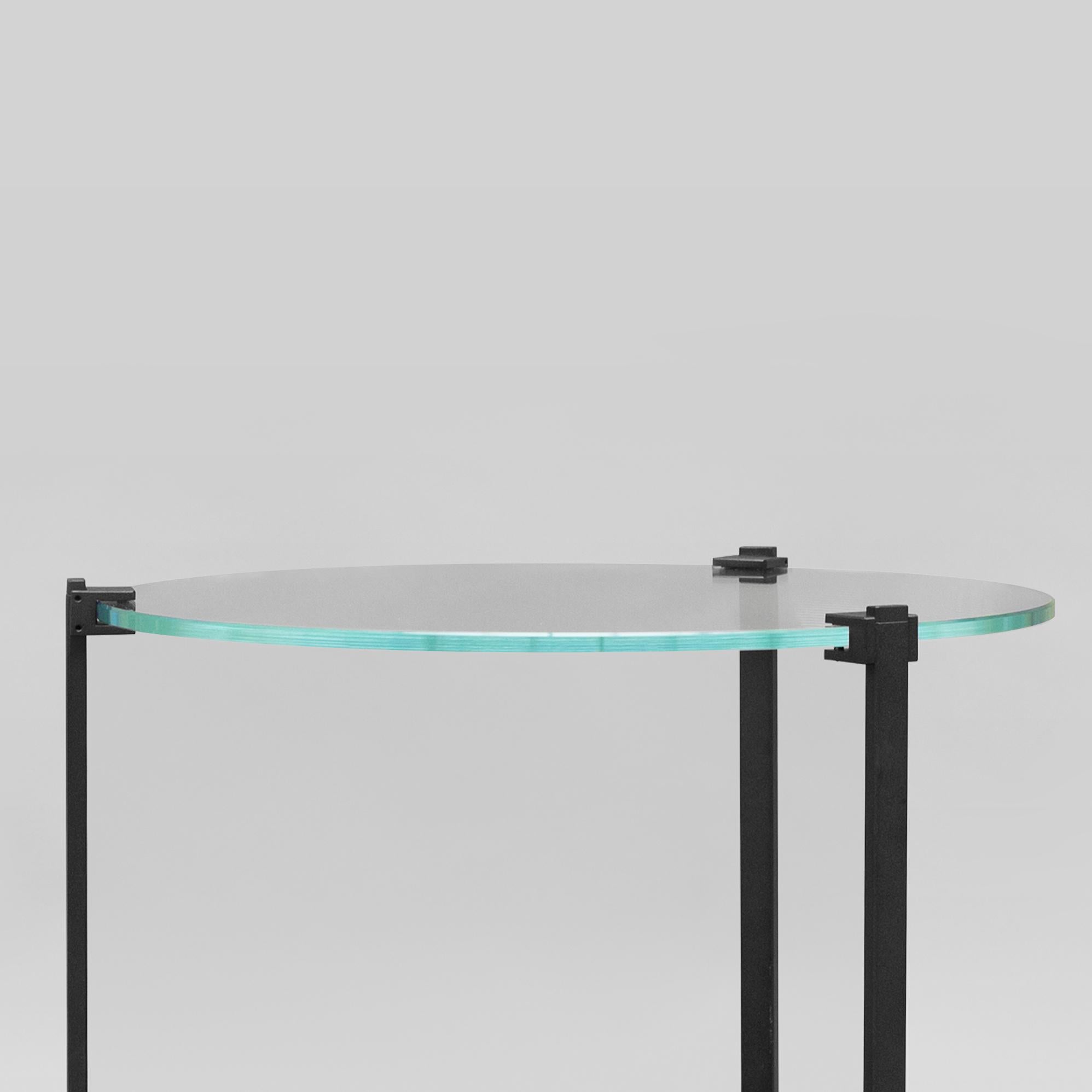 Contemporary Sidetable designed by Peter Ghyczy.
Manufactured by Ghyczy (Netherlands)

The T79 is versatile as it is modest. Three stainless steel legs are secured to the glass top by cast metal details. To be ordered in different heights and