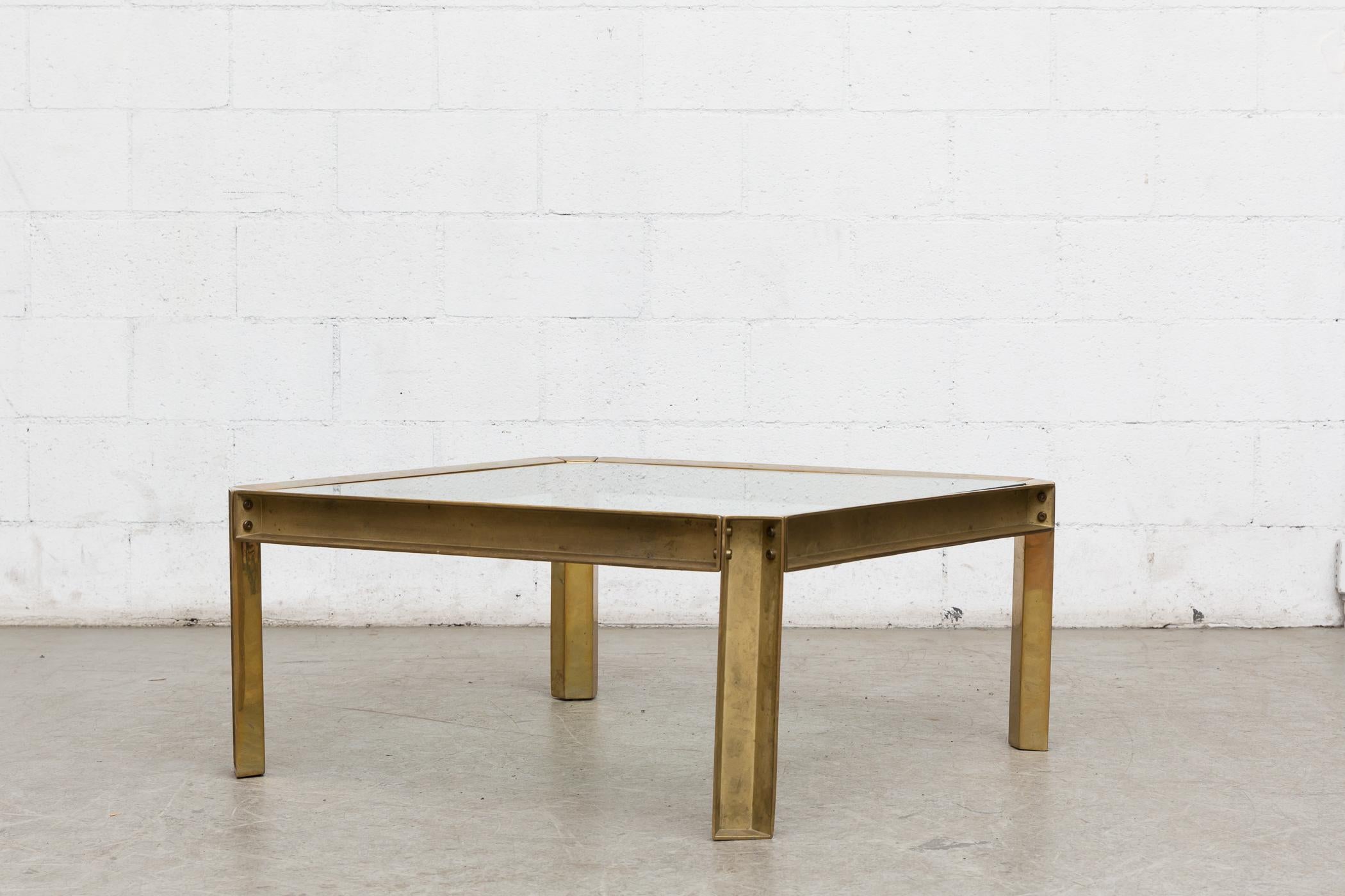 Industrial looking brass and glass coffee table with a raw construction look. Original condition with nice patina. Peter Ghyczy studied architecture with an industrial design background at the polytechnic University Aachen, and is recognized for his