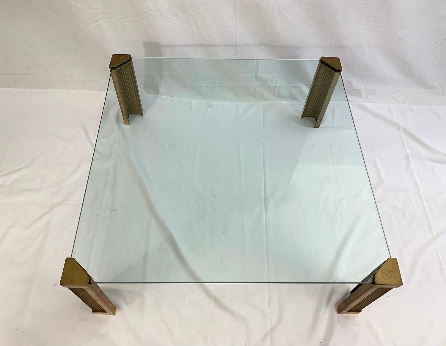 Coffee table or side table, model T14, Peter Ghyczy, Netherlands, 1970s.

This sculptural table is made of a thick glass top held by four heavy brass feet molded into the sand. The legs of the T14 table have a smooth outline and fluted panels with a