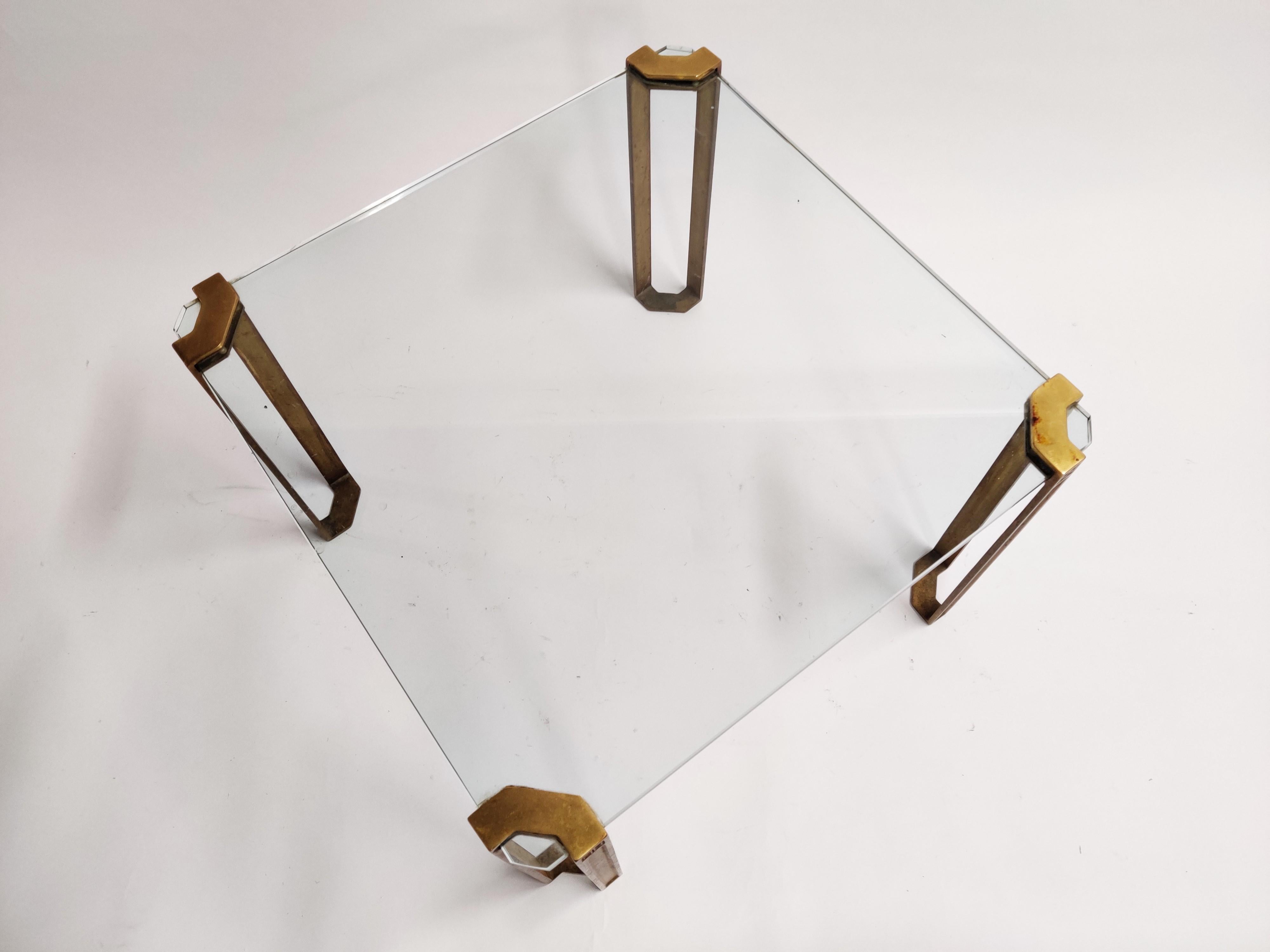 T24 Pioneer square end or coffee table made from cast brass legs designed by Peter Ghyczy.

Beautiful design featuring his pioneering casting techniques and way of suspending glass and metal.

Thick 15 mm clear glass tabletop.

Beautiful