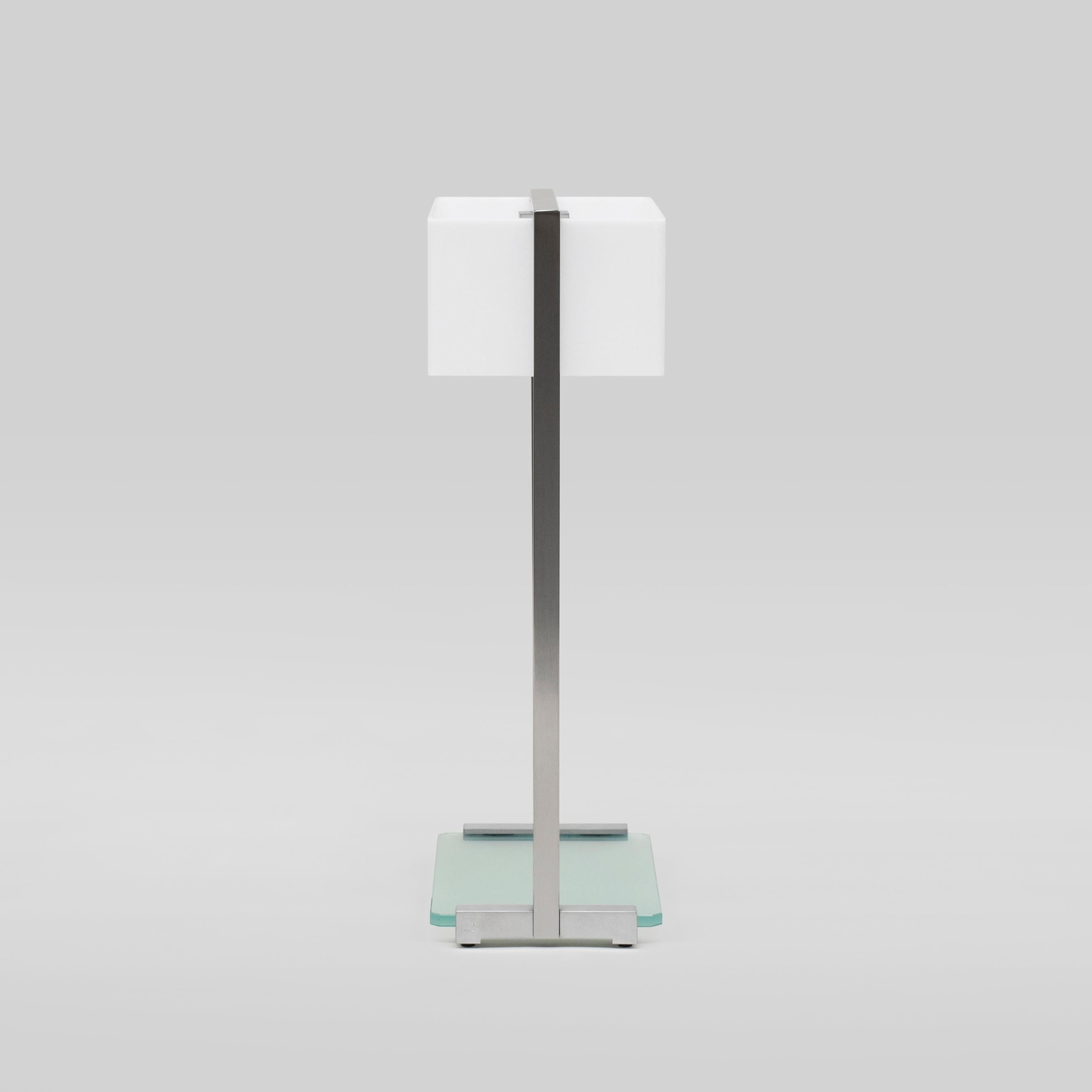 Table Lamp designed by Peter Ghyczy in 2006.
Manufactured by Ghyczy (Netherlands)

This table lamp is a multi-tasker. The spacious construction of high quality metals leaves room for multiple ways of use as a bedside or table lamp or even a display